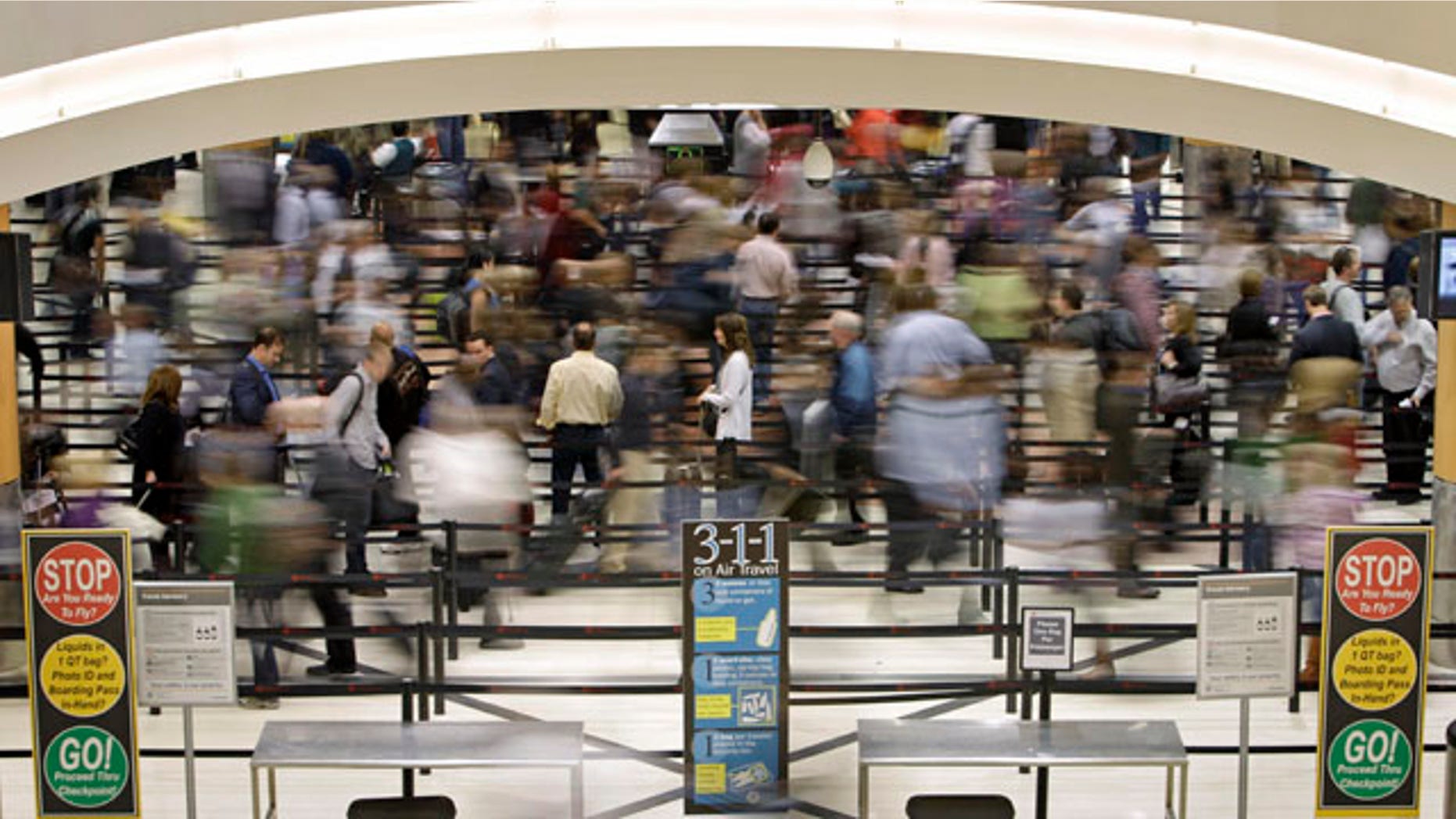Nov. 18: Passengers move through the line at a security checkpoint at Hartsfield-Jackson Atlanta International Airport in Atlanta. Experts say the TSA faces an all but impossible task: stand as the last line against unknown terror without treating everyone as a potential terrorist.