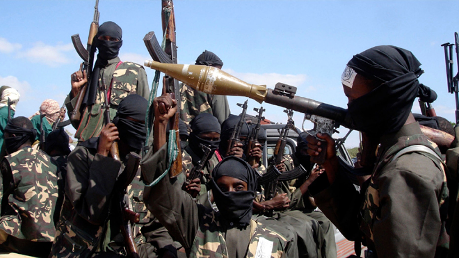 In this Dec. 8, 2008 file photo, armed al-Shabaab fighters on pickup trucks prepare to travel into the city, just outside Mogadishu, in Somalia.