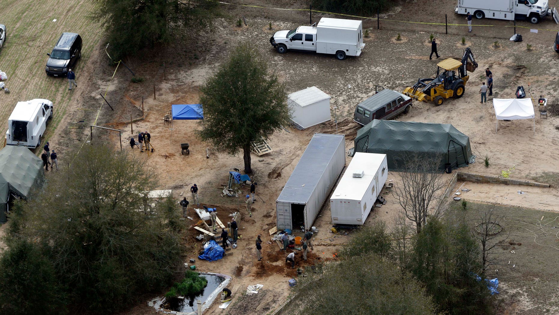 Feb. 8, 2013: Authorities continue their investigation at the site in Midland City, Ala., where a five year old boy was held hostage in an underground bunker before being rescued.
