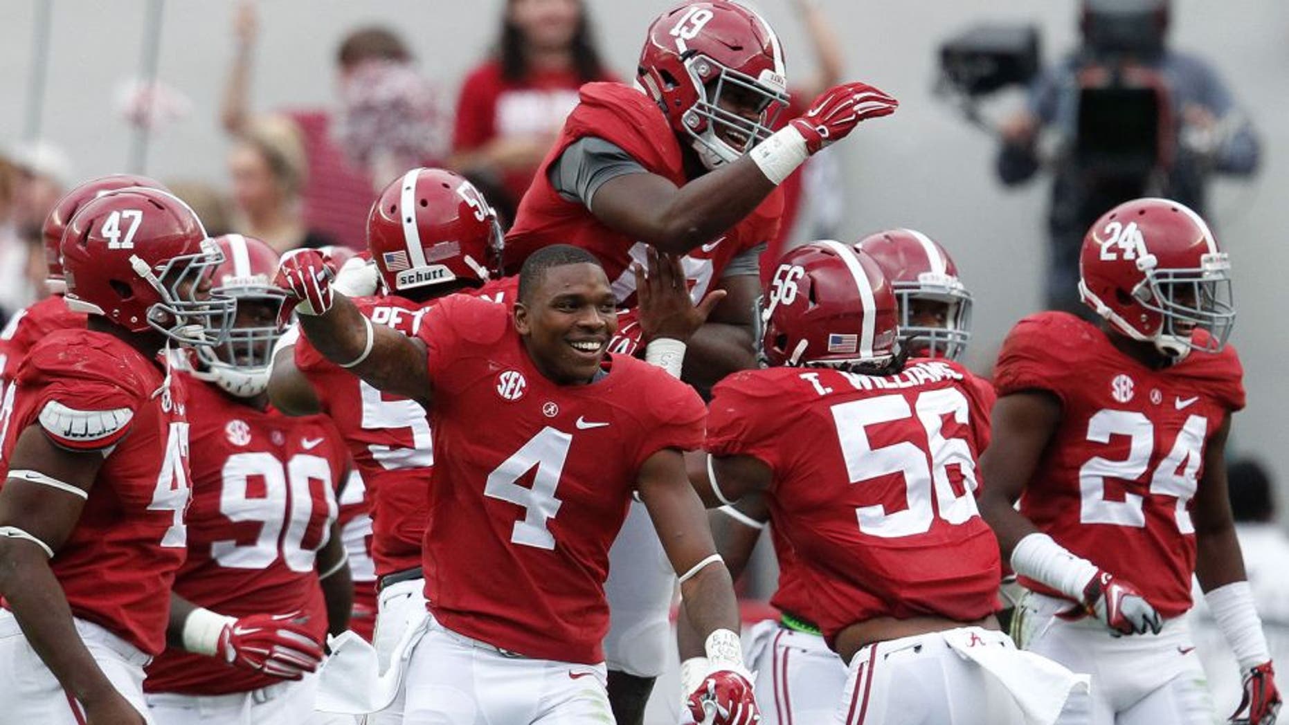 Oct 18, 2014; Tuscaloosa, AL, USA; Alabama Crimson Tide linebacker Reggie Ragland (19) is congratulated by teammates after he intercepted a pass from Texas A&M Aggies quarterback Kenny Hill (not shown) at Bryant-Denny Stadium. The Crimson Tide defeated the Aggies 59-0. Mandatory Credit: Marvin Gentry-USA TODAY Sports