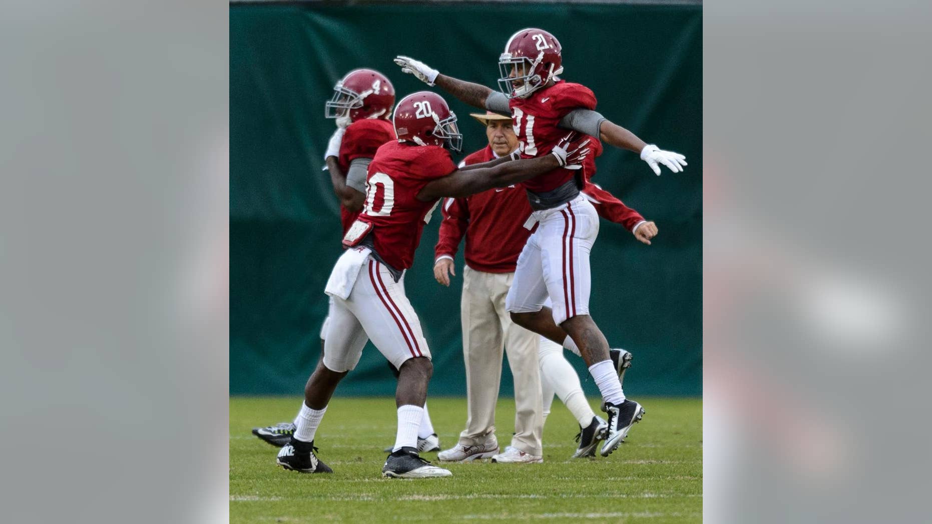 Alabama head coach Nick Saban tracks Alabama defensive backs Jarrick Williams (20) and Maurice Smith (21) as they work through drills during Alabama football practice, Tuesday, November 25, 2014, at the Thomas-Drew Practice Facility in Tuscaloosa, Ala. (AP Photo/AL.com, Vasha Hunt ) MAGS OUT (