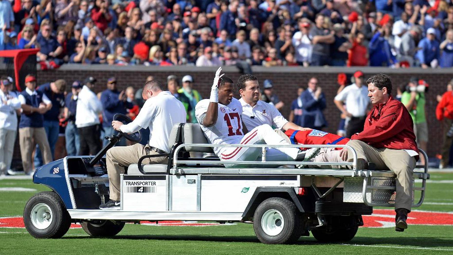 Alabama running back Kenyan Drake (17) waves while being taken off the field after an injury inring the first half of an NCAA college football game against Mississippi in Oxford, Miss., Saturday, Oct. 4, 2014. (AP Photo/The Daily Mississippian, Thomas Graning)