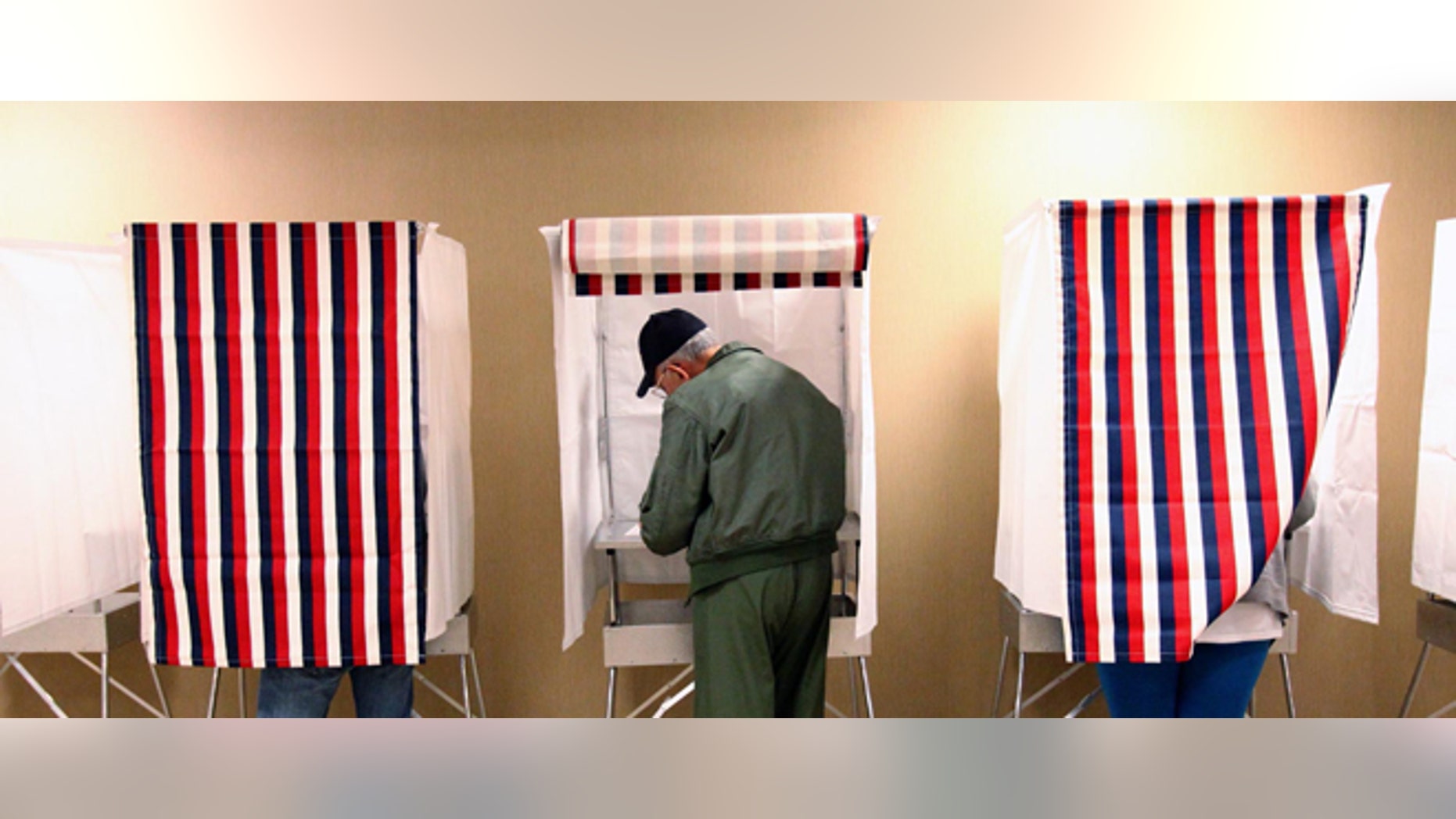 Northport resident Ronald Hampel, center, casts his ballot at the Northport City Hall voting location in Northport, Ala. Tuesday, Nov. 6, 2012. After a grinding presidential campaign President Barack Obama and Republican presidential candidate, former Massachusetts Gov. Mitt Romney, yield center stage to American voters Tuesday for an Election Day choice that will frame the contours of government and the nation for years to come. (AP Photo/The Tuscaloosa News, Dusty Compton)