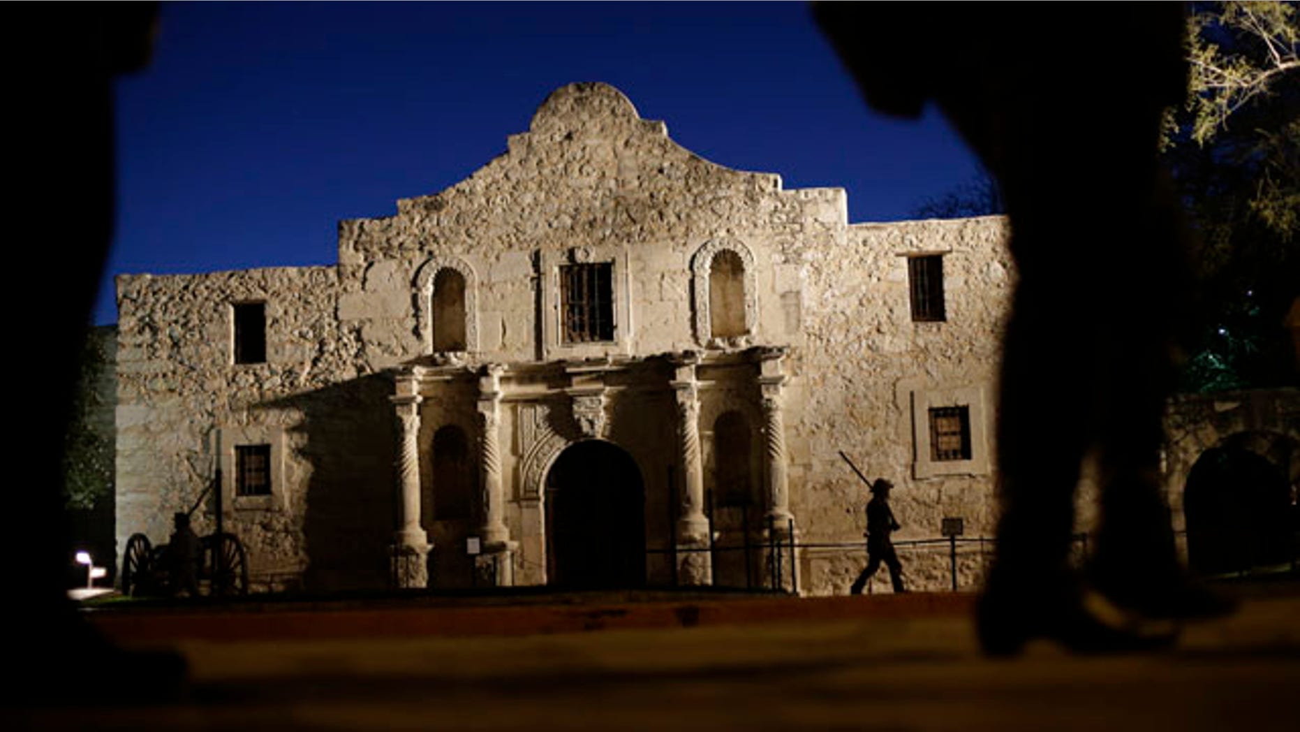 File - In this March 6, 2013, file photo, Dan Phillips, a member of the San Antonio Living History Association, patrols the Alamo during a pre-dawn memorial ceremony to remember the 1836 Battle of the Alamo and those who fell on both sides. (AP Photo/Eric Gay, File)