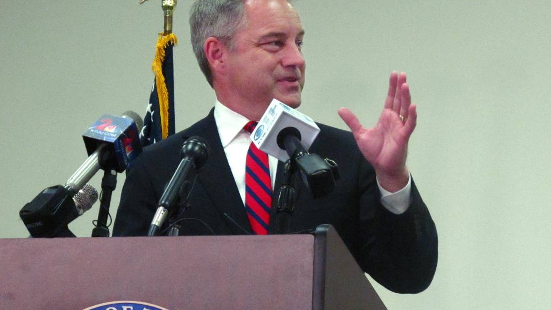 Alaska Gov. Sean Parnell tells an audience in Anchorage, Alaska, the amount of this year's Permanent Fund Dividend that will go to most residents just for living in the state, Wednesday, Sept. 17, 2014. The $1,884 payout set for Oct. 2 is more than double the amount of last year's $900 checks. (AP Photo/Rachel D'Oro)