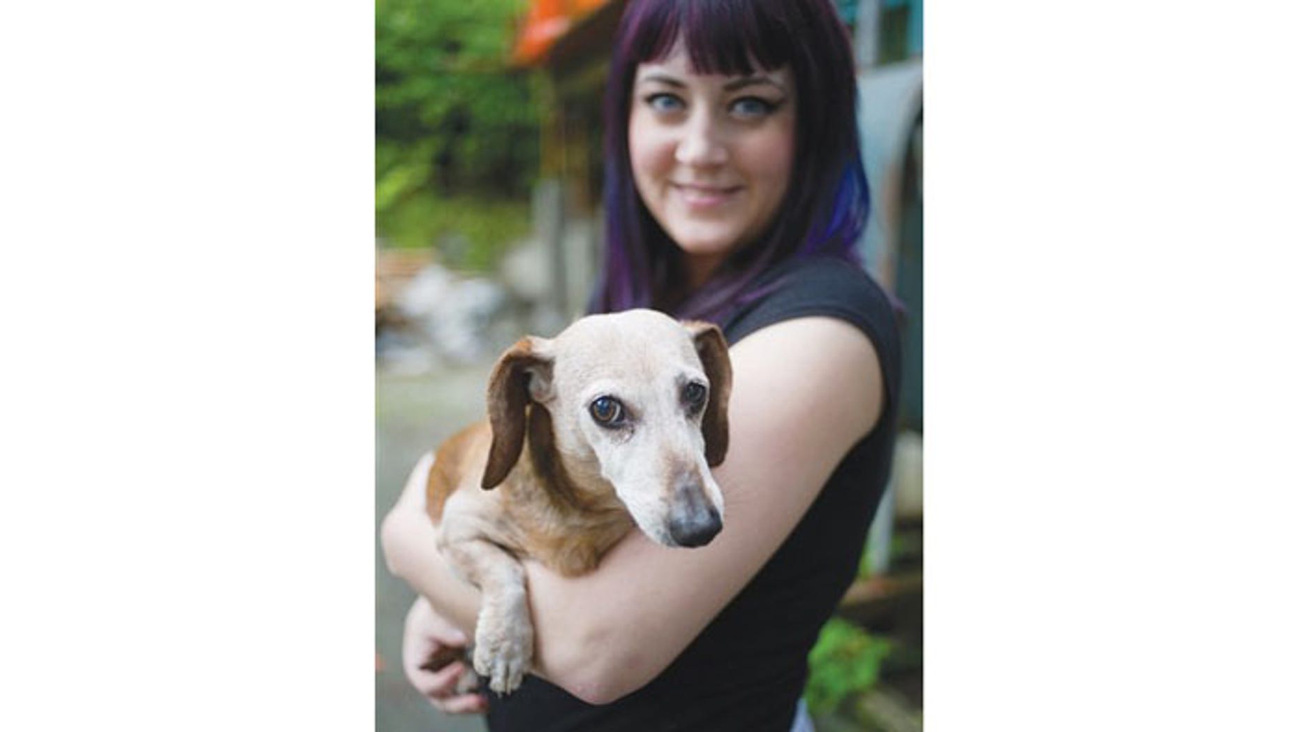 August 30: Brook Collins holds her dog, Fudge, at her home in Juneau, Alaska.