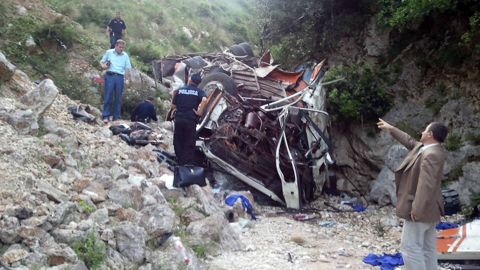 May 21: Rescue personnel attend the scene of a bus accident as the bus lies at the bottom of a cliff near Himare southern Albania. The bus had been heading from the city of Elbasan to the southern city of Saranda. Police spokeswoman Klejda Plangarica said the bus fell some 80 meters (yards) off the road in Qafa e Vishes near the town of Himare, 137 miles (220 kilometers) south of the capital, Tirana, on Monday afternoon.