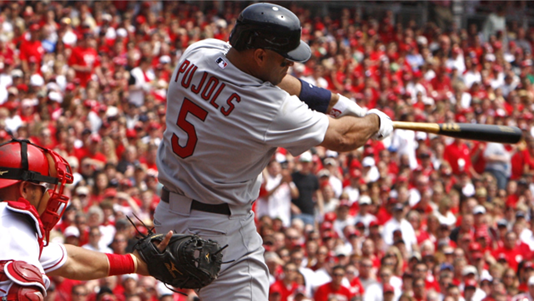 St. Louis Cardinals' Albert Pujols hits a solo home run off Cincinnati Reds pitcher Aaron Harang in the first inning of a baseball game, Monday, April 5, 2010, in Cincinnati. Cincinnati Reds' Ramon Hernandez catches at left.