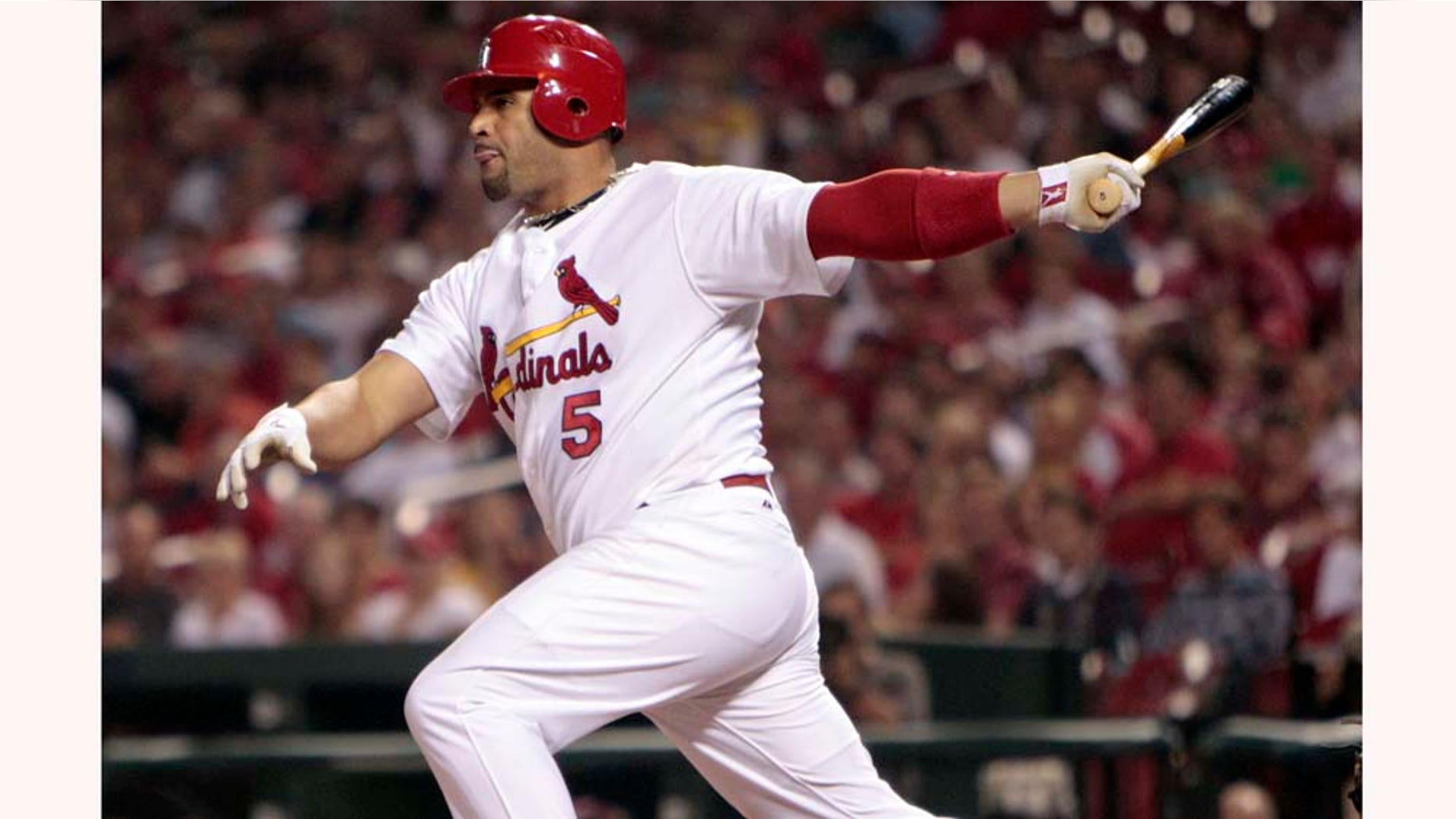 FILE - This Sept. 17, 2010, file photo shows St. Louis Cardinals' Albert Pujols hitting an RBI-double during the first inning of a baseball game against the San Diego Padres, in St. Louis. Pujols is seeking a deal that would make him one of baseball's highest-paid players. (AP Photo/Jeff Roberson, File)