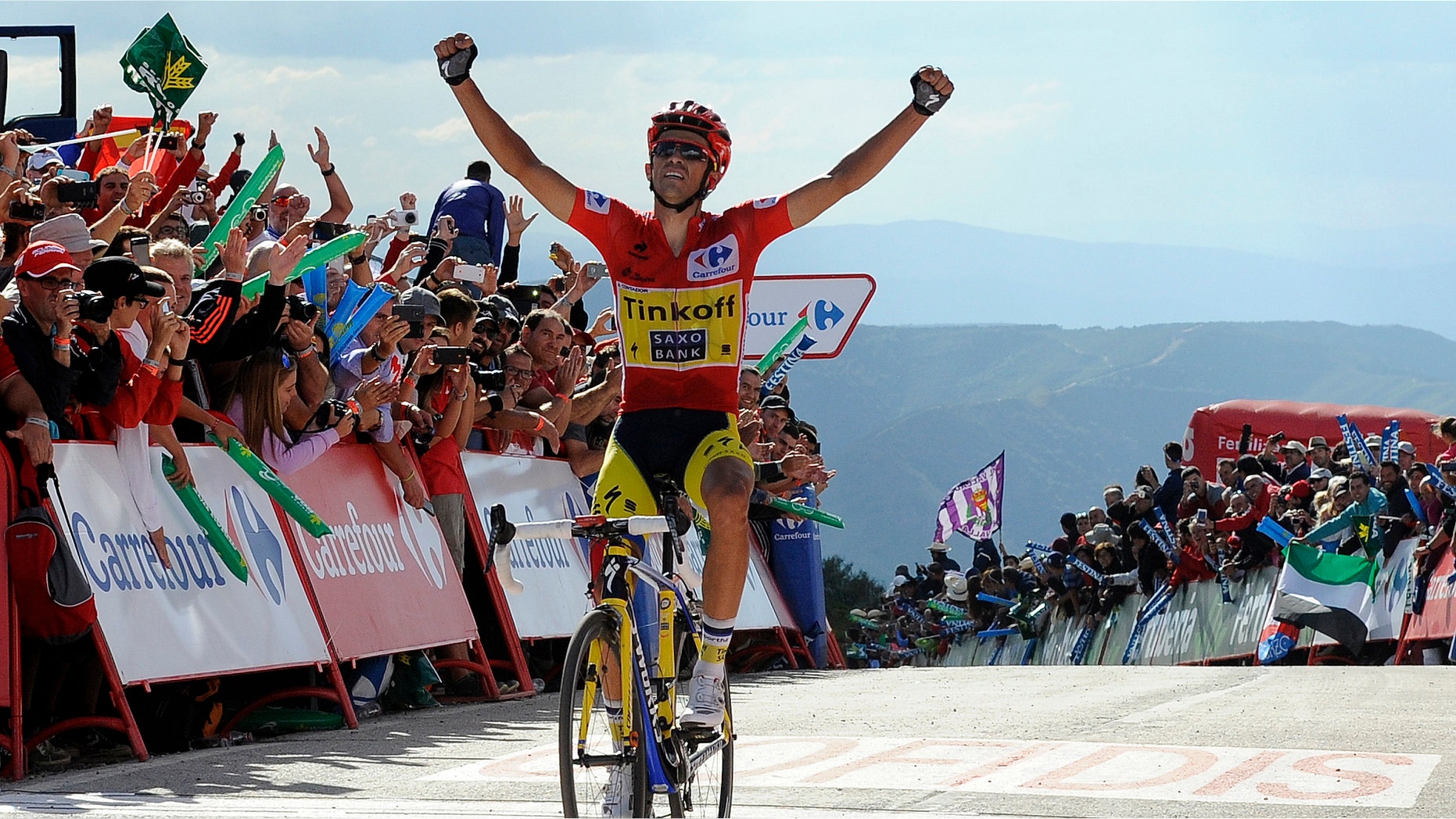 Alberto Contador of Spain wins the 20th stage of the Spanish Vuelta cycling, a 185.7-kilometer (115-mile) ride between Santo Estevo De Ribas De Sil and Puerto De Ancares, Spain, Saturday, Sept. 13, 2014. Contador won the 20th stage of the Spanish Vuelta Saturday and consolidated his leadership. The 21-stage race ends tomorrow, Sept. 14, in Santiago de Compostela. (AP Photo/Paulo Duarte)