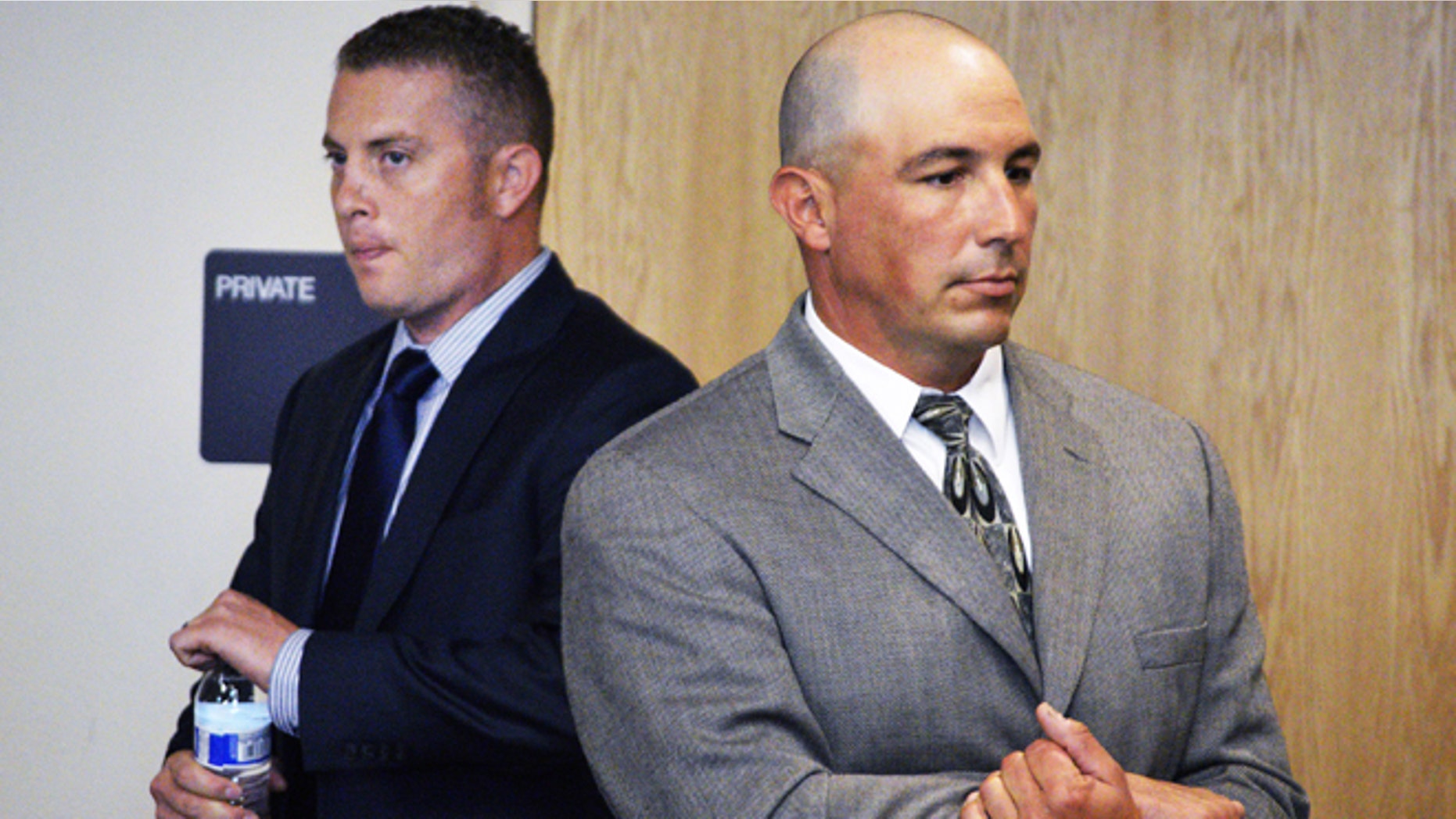 FILE - In a Monday, Aug. 3, 2015 file photo, Albuquerque officer Dominique Perez, left, and former Albuquerque Detective Keith Sandy, right, stand up in court at a preliminary hearing in Albuquerque, N.M. Pro Tem Judge Neil Candelaria is scheduled Monday, Aug. 17, 2015, to hear more testimony in a preliminary hearing for Perez and Sandy. They are facing murder charges for the death of James Boyd, who was shot during a standoff in March 2014 in the Sandia Mountains foothills. (AP Photo/Russell Contreras, File)
