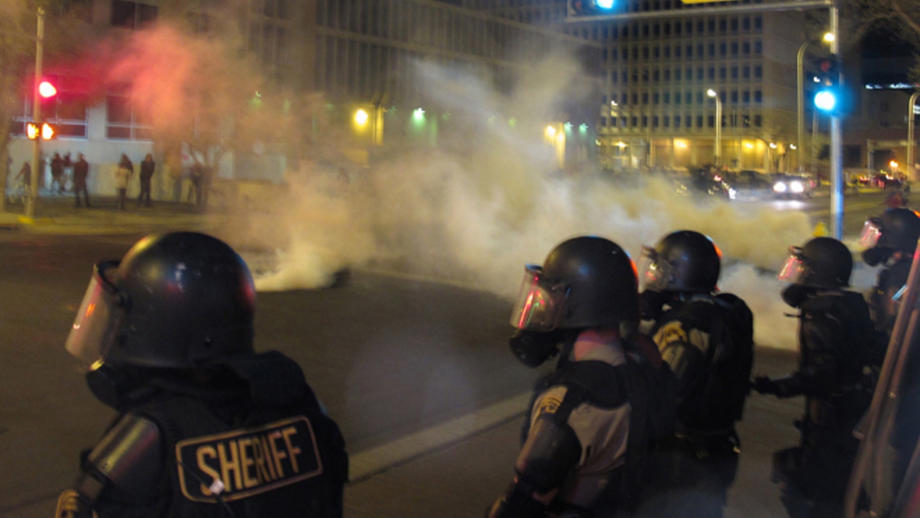 Riot police launch tear gas in downtown Albuquerque, N.M. following a 10-hour protest around the city, March 30, 2014.