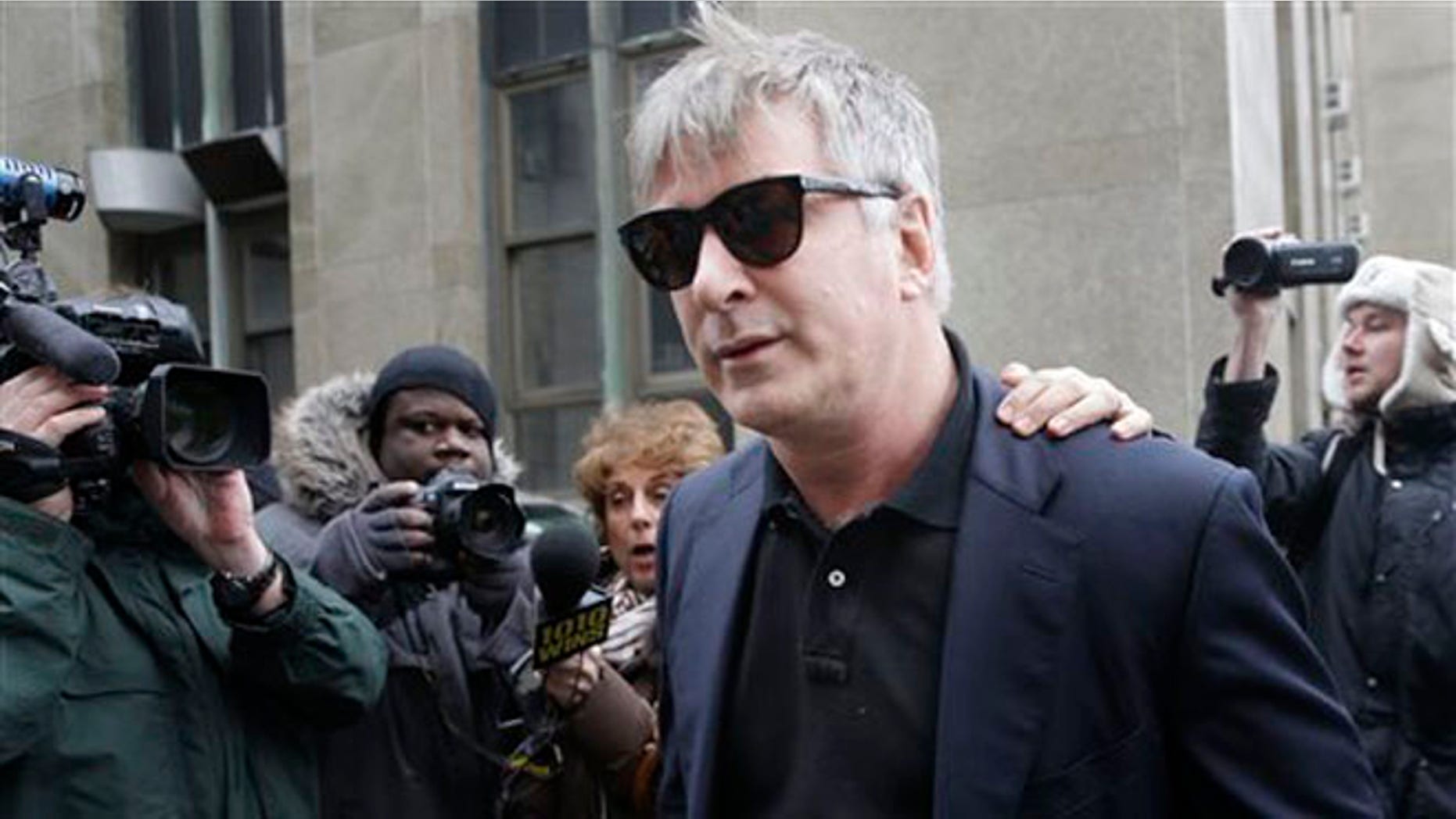 In this Tuesday, Nov. 12, 2013 file photo, actor Alec Baldwin leaves criminal court in New York.