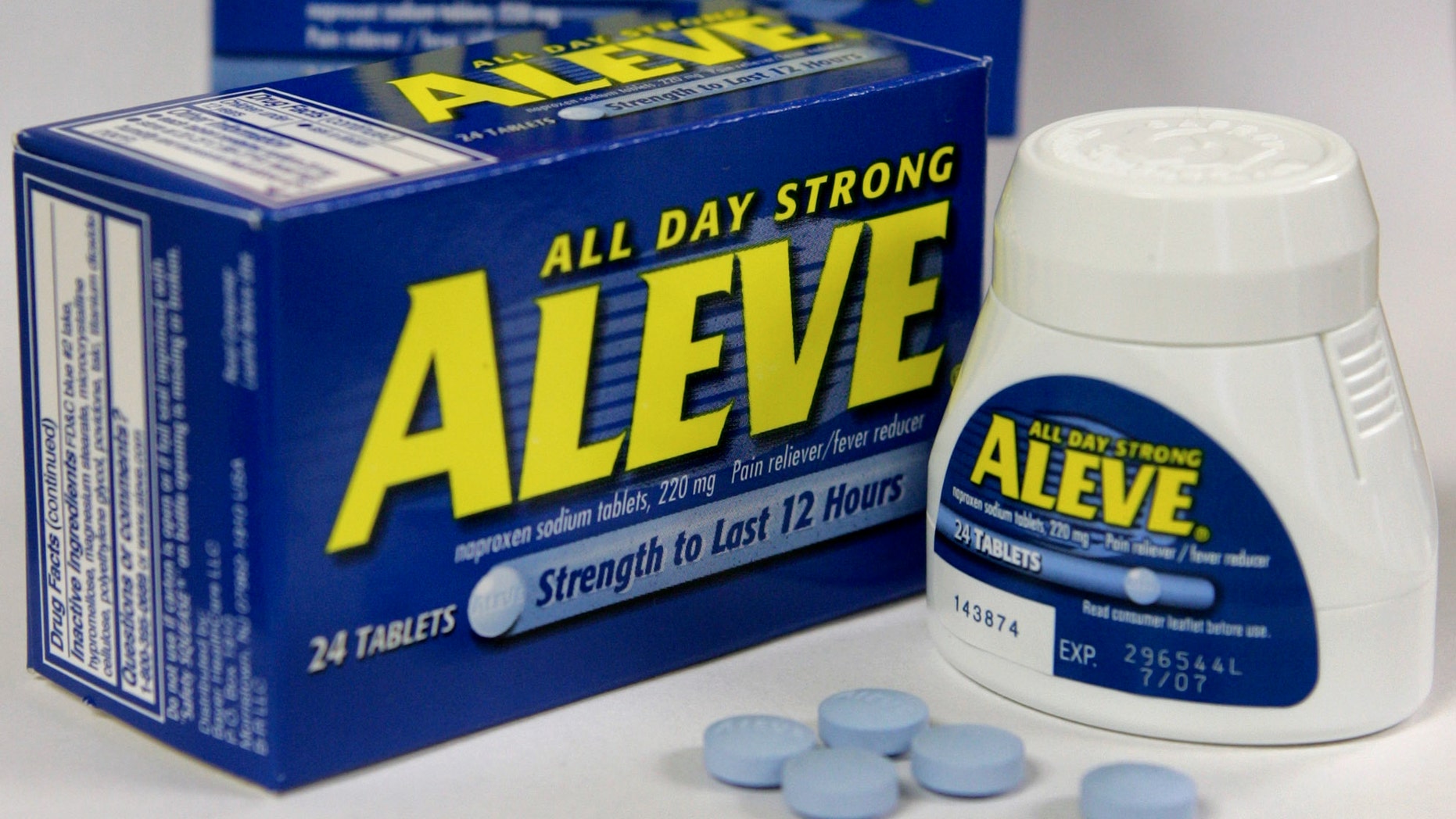 Several Aleve tablets appear in front of bottles of the pain reliever. (AP Photo/Steven Senne, File)
