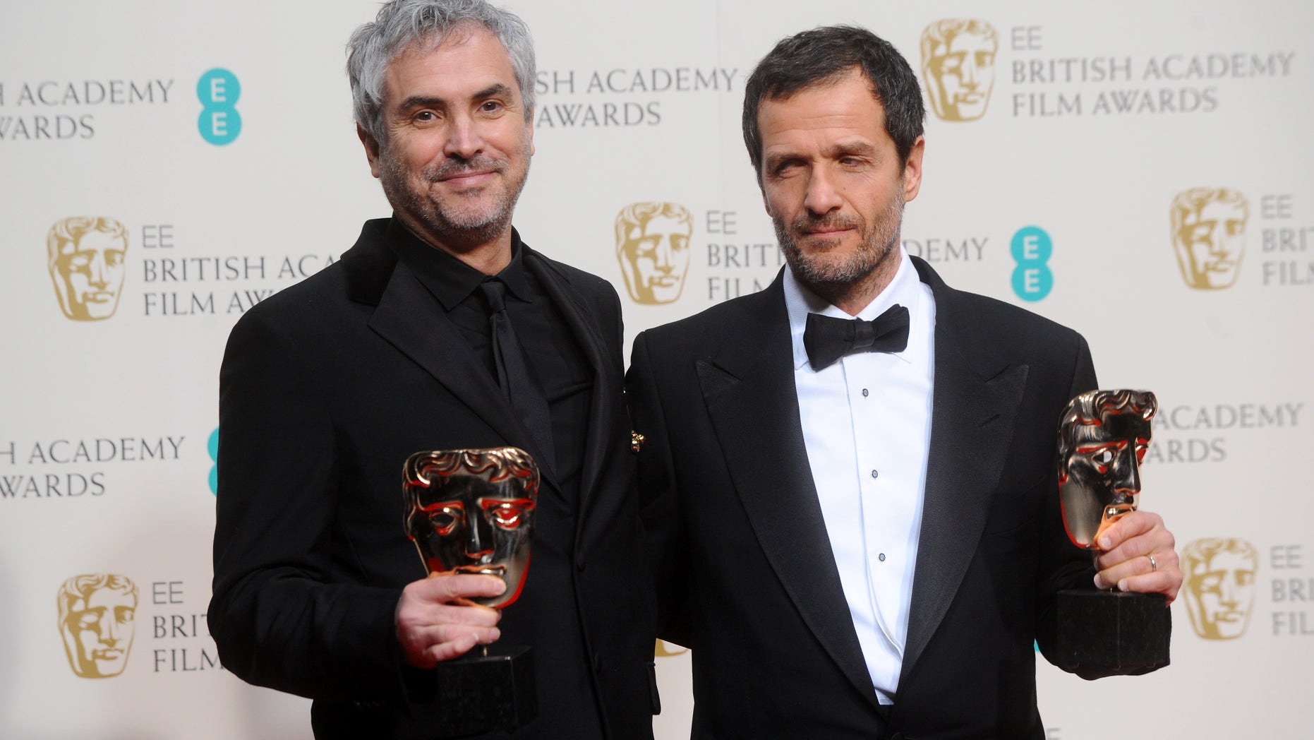 LONDON, ENGLAND - FEBRUARY 16: Director Alfonso Cuaron and producer David Heyman, winner of the Outstanding British Film award, pose in the winners room at the EE British Academy Film Awards 2014 at The Royal Opera House on February 16, 2014 in London, England. (Photo by Anthony Harvey/Getty Images)