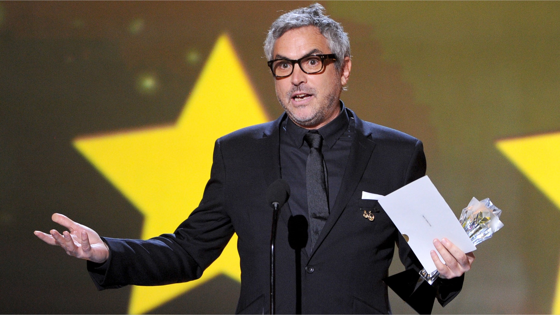 SANTA MONICA, CA - JANUARY 16: Director Alfonso Cuarón accepts the Best Director award for "Gravity" onstage during the 19th Annual Critics' Choice Movie Awards at Barker Hangar on January 16, 2014 in Santa Monica, California. (Photo by Kevin Winter/Getty Images)