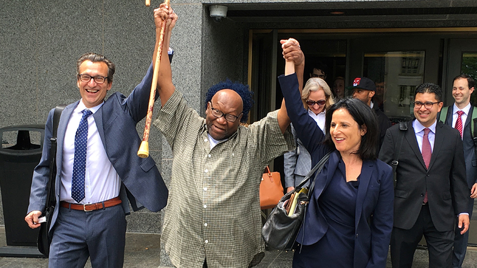 Alfred Swinton and his lawyers walk out of Superior Court in Hartford, Conn., Thursday, June 8, 2017, after a judge dismissed his murder conviction in a 1991 killing. Swinton was released and will be under house arrest while the murder charge remains pending. New DNA testing showed he wasn't the source of bite marks on the victim's body. (AP Photo/Dave Collins)
