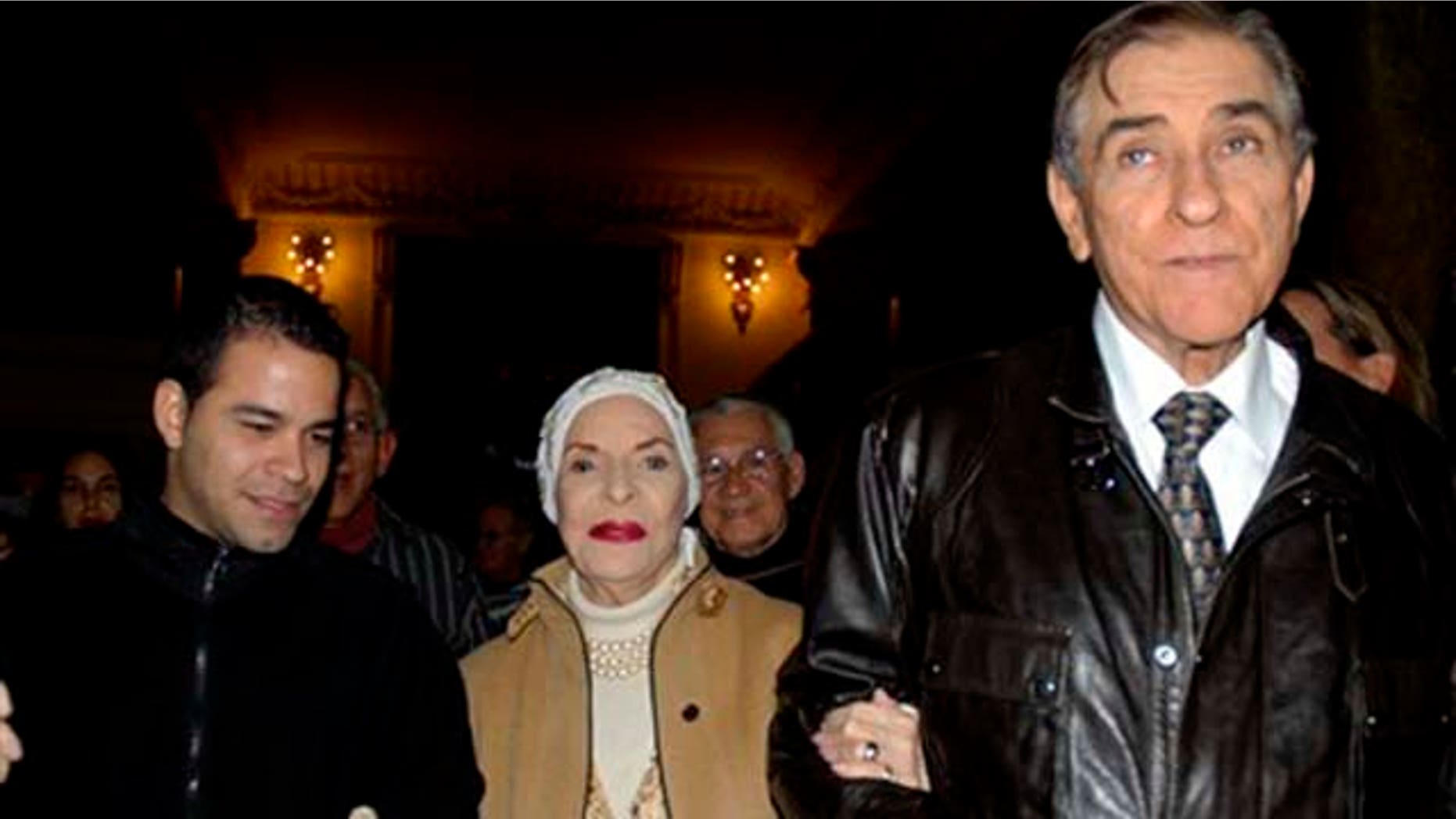 Cuban dance legend Alicia Alonso, center, is accompanied by her husband Fernando Alonso, right, as they leave a gala honoring the prima ballerina on the eve of her 90th birthday, in Havana, Cuba, Monday Dec. 20, 2010. Alonso is considered a living legend of international ballet and a national treasure in her native Cuba. (AP Photo)
