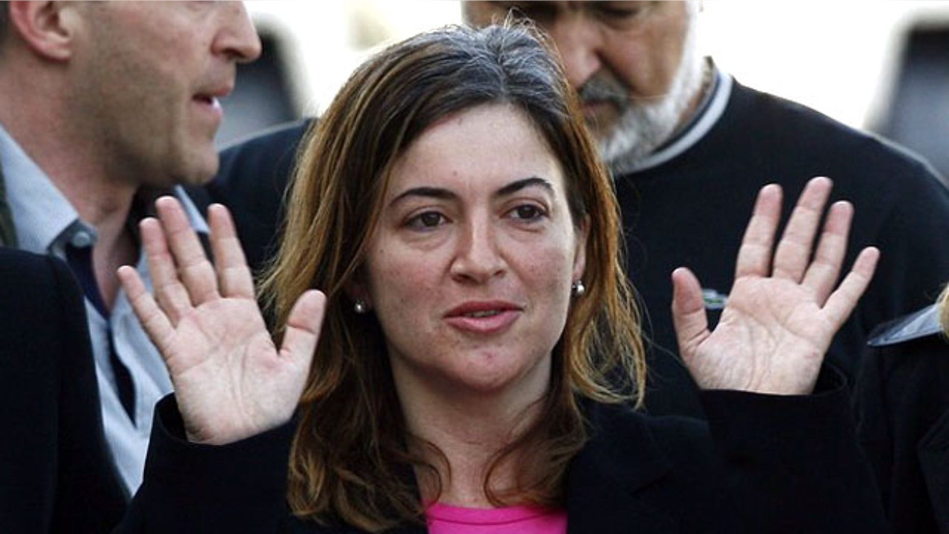 Alicia Gamez gestures during her arrival at Barcelona's airport March 10, 2010. Gamez, who was held hostage in Mali by a group believed to be al Qaeda's wing in North Africa, has been freed, the Spanish government said on Wednesday. Aid-worker Gamez was part of an aid convoy travelling to southern Senegal when she was seized in northern Mauritania in November along with two Spanish colleagues Albert Vilalta and Roque Pascual.