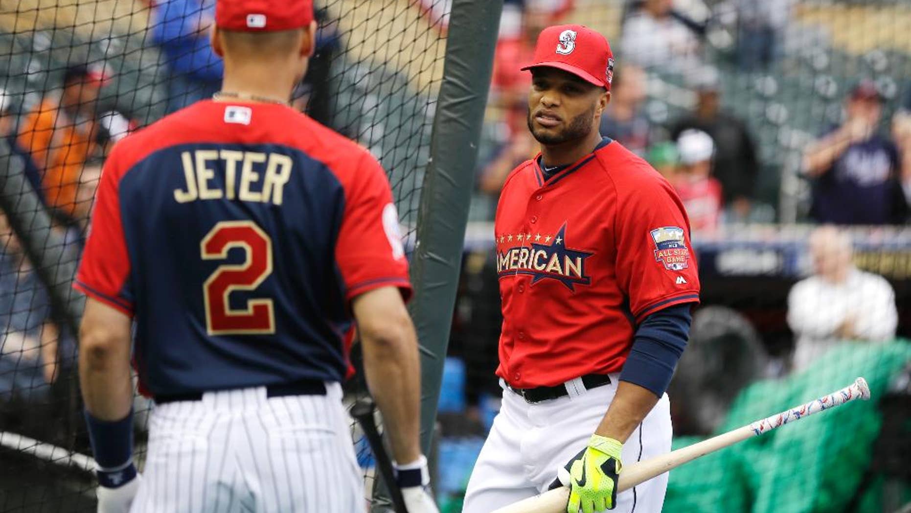 American League second baseman Robinson Cano, of the Seattle Mariners, right, talks with teammate short stop Derek Jeter, of the New York Yankees, during batting practice for the MLB All-Star baseball game, Monday, July 14, 2014, in Minneapolis. (AP Photo/Jeff Roberson)