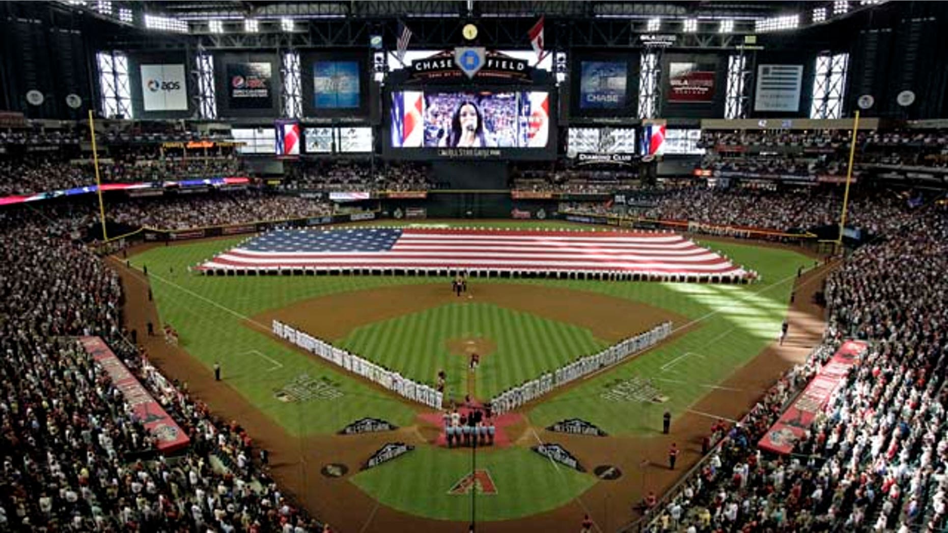 National and American League teams line the field as Jordin Sparks sings the national anthem before the MLB All-Star baseball game Tuesday, July 12, 2011, in Phoenix. (AP Photo/Matt York)