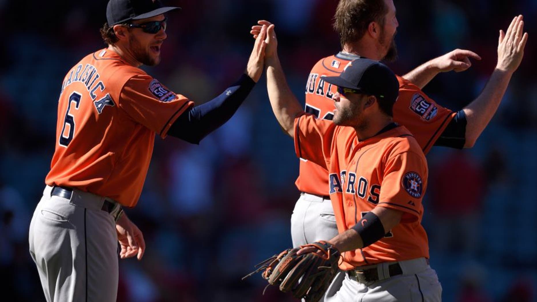 ANAHEIM, CA - SEPTEMBER 13: Jake Marisnick #6 and Jose Altuve #27 of the Houston Astros high-five while celebrating after defeating the Los Angeles Angels of Anaheim 5-3 at Angel Stadium of Anaheim on September 13, 2015 in Anaheim, California. (Photo by Matt Brown/Angels Baseball LP/Getty Images)