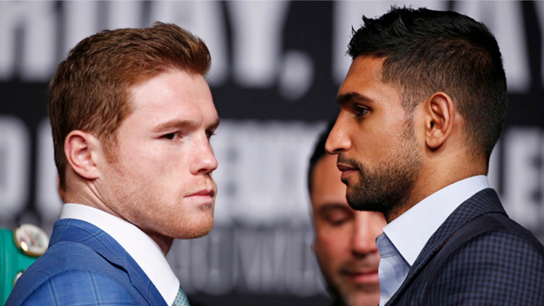 Amir Khan, right, and Canelo Alvarez pose for photographers during a news conference at the MGM Grand, Wednesday, May 4, 2016, in Las Vegas. The two are scheduled to fight in a middleweight title bout Saturday in Las Vegas. (AP Photo/John Locher)