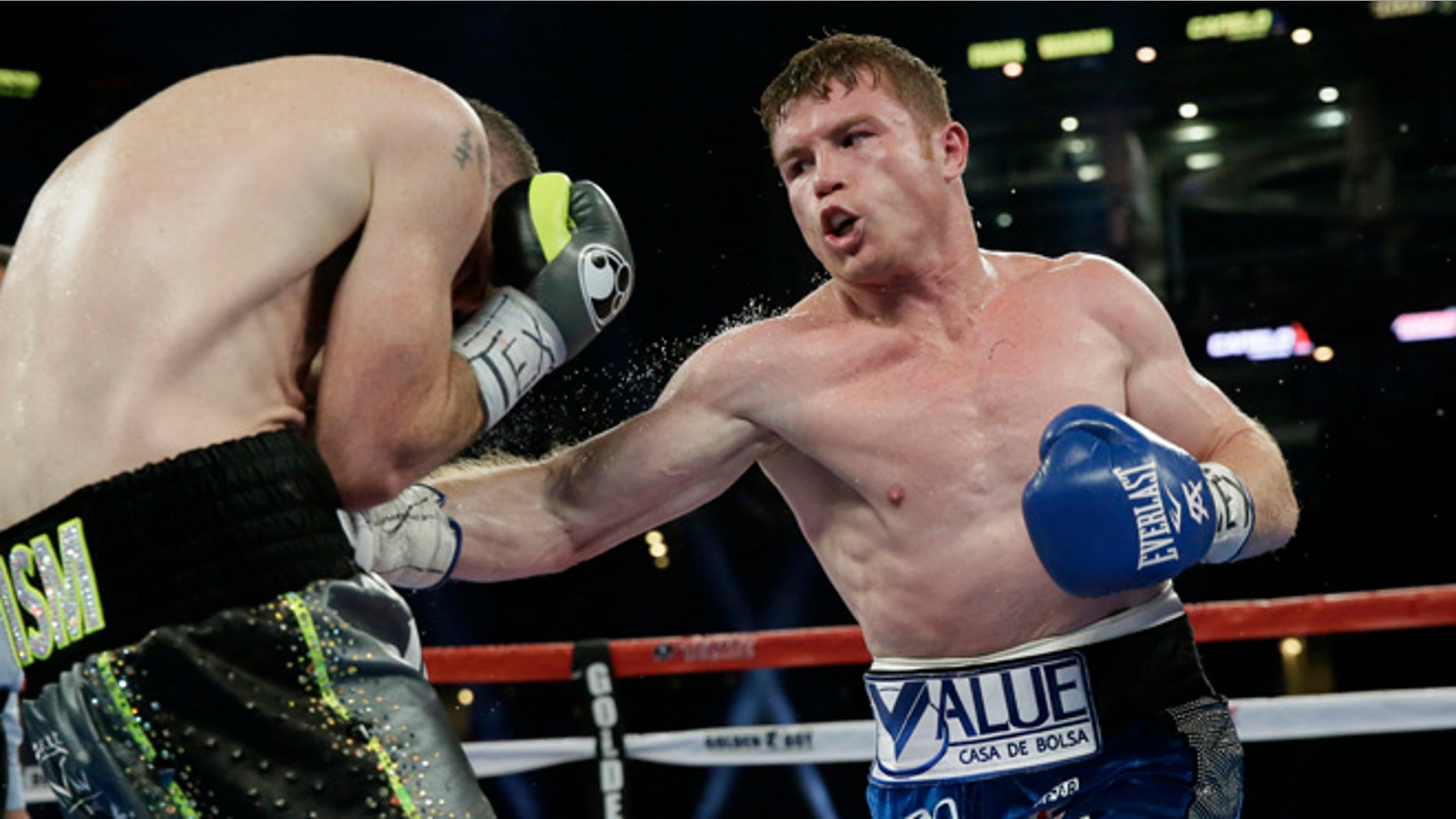 Canelo Alvarez, right, punches Liam Smith, left, during the fifth round of the WBO Junior Middleweight championship boxing match at the stadium in Arlington, Texas, Saturday, Sept. 17, 2016. Alvarez won by a knock out in the ninth round. (AP Photo/LM Otero)