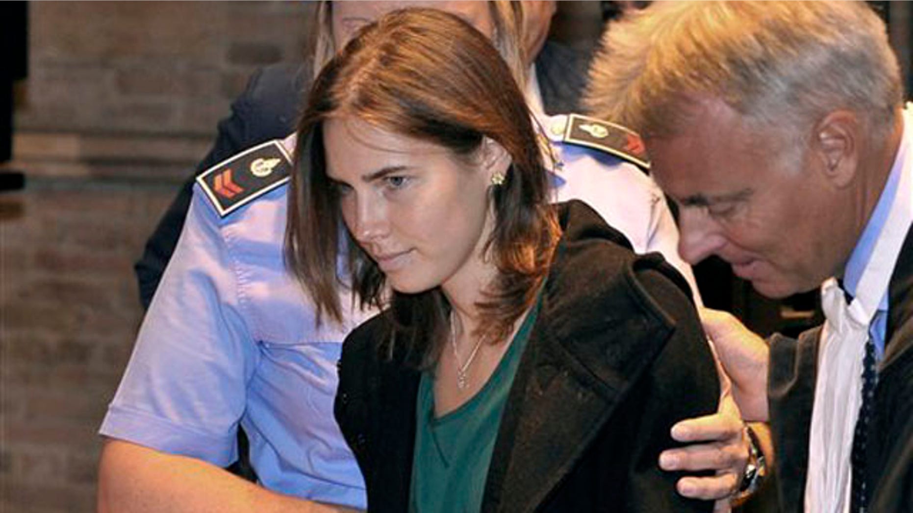 Amanda Knox, accompanied by her lawyer Carlo Dalla Vedova, arrives for an appeal hearing at the Perugia court, central Italy, Monday, Oct. 3, 2011. A tearful Amanda Knox has told an appeals court in Italy that accusations that she killed her British roommate are unfair and groundless. Knox fought back tears as she addressed the court Monday, minutes before the jury went into deliberations to decide whether to uphold her murder conviction. A verdict is expected later in the day. (AP Photo/Antonio Calanni)
