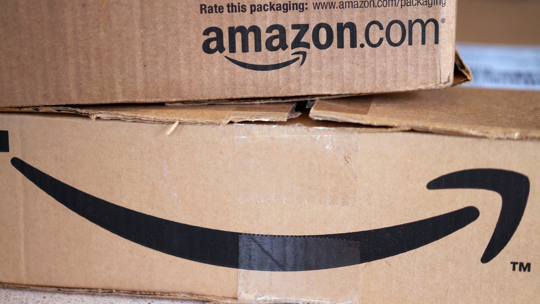 Two freshly delivered Amazon boxes are seen on a counter in Golden, Colorado August 27, 2014. With people increasingly accessing the Internet from smartphones and tablets, online companies ranging from social networks such as Facebook Inc to e-commerce companies like Amazon.com Inc have been investing heavily to develop their mobile platforms. REUTERS/Rick Wilking (UNITED STATES - Tags: BUSINESS SCIENCE TECHNOLOGY TELECOMS) - RTR44130