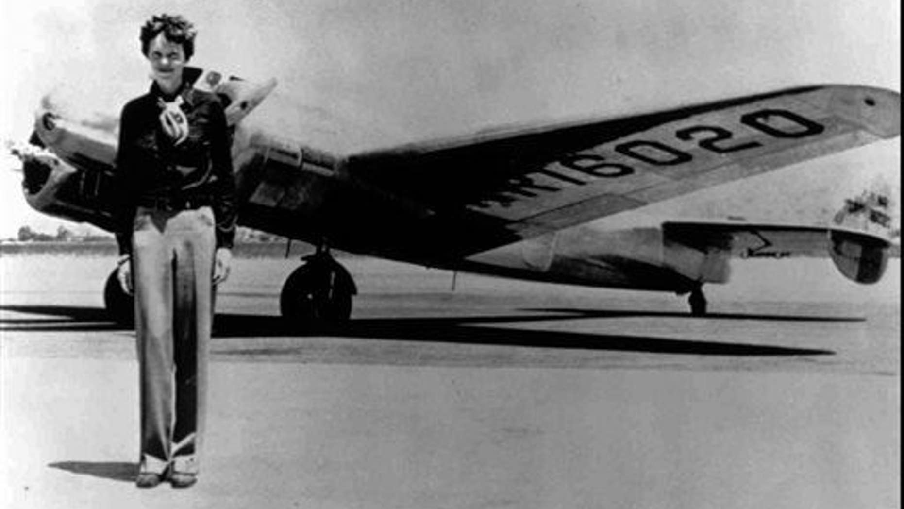 In this undated file photo, Amelia Earhart stands next to a Lockheed Electra 10E, before her last flight in 1937 from Oakland, Calif., bound for Honolulu on the first leg of her record-setting attempt to circumnavigate the world westward along the Equator.