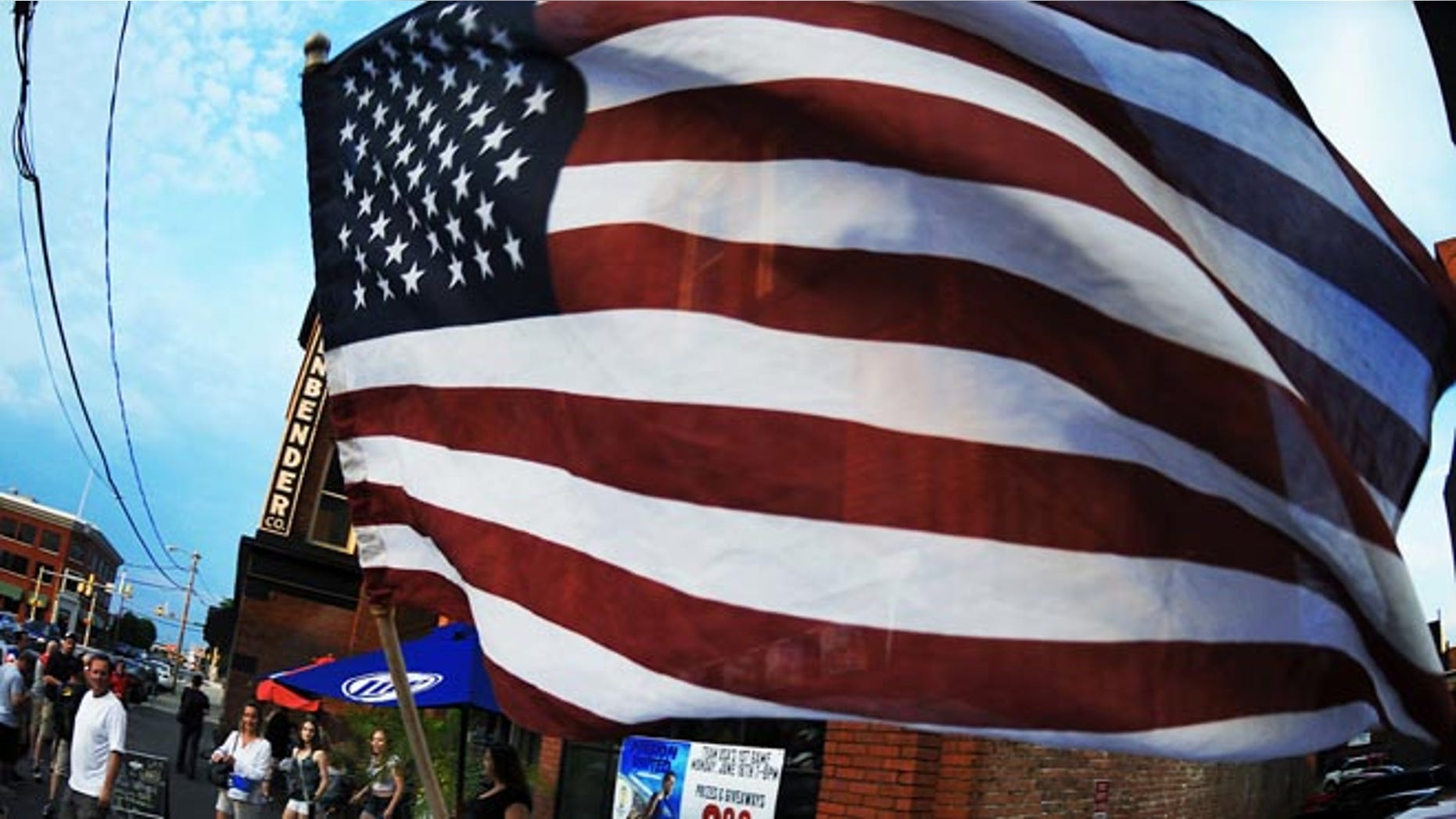 Soccer fan waves the U.S. Flag in downtown Scranton, Pa. on Monday, June 16, 2014.