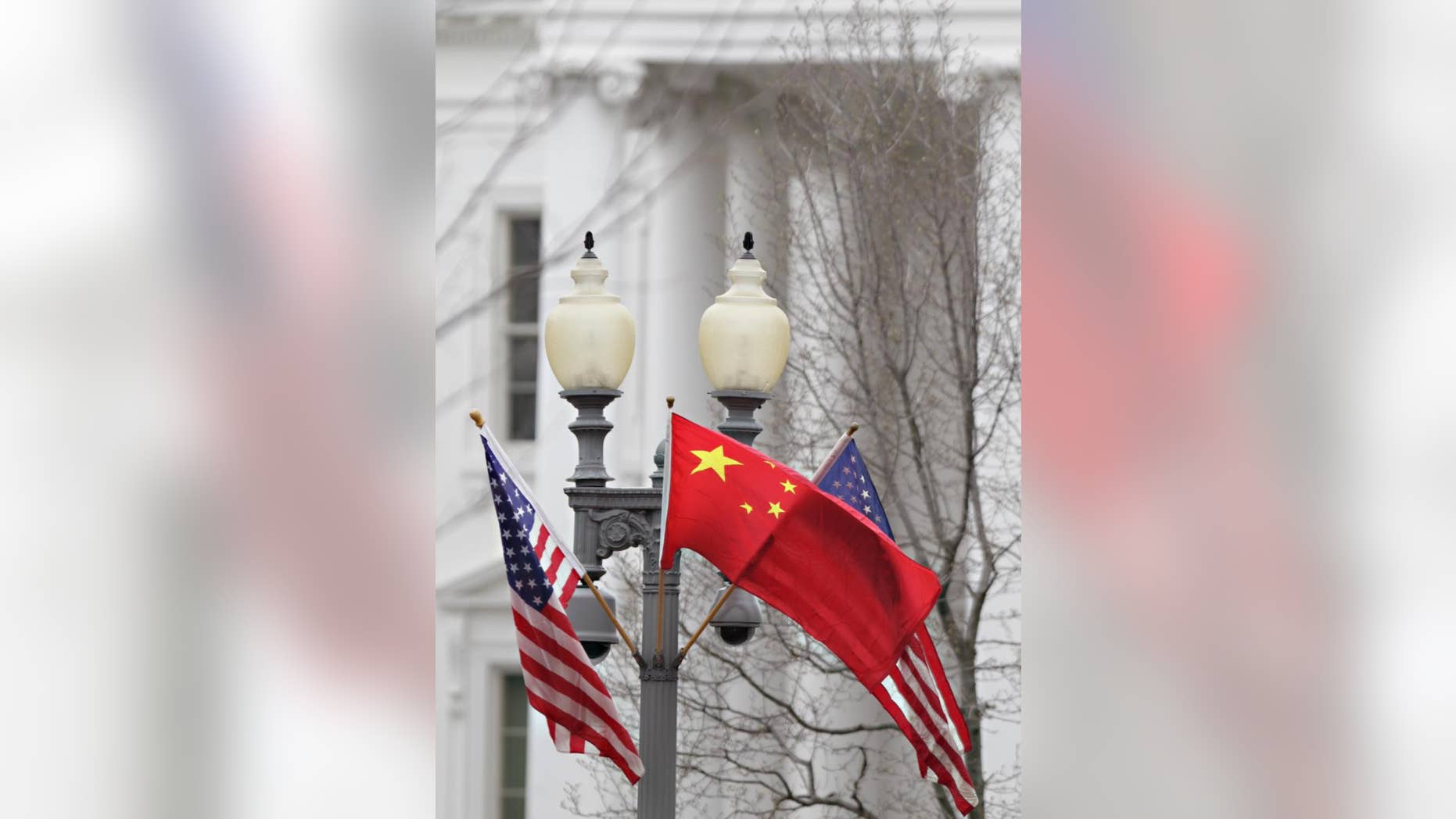 American and Chinese flags fly along Pennsylvania Avenue in front of the White House in Washington, Monday, Jan. 17, 2011. On Wednesday, Chinese President Hu Jintao arrives for a state visit. (AP Photo/Carolyn Kaster)