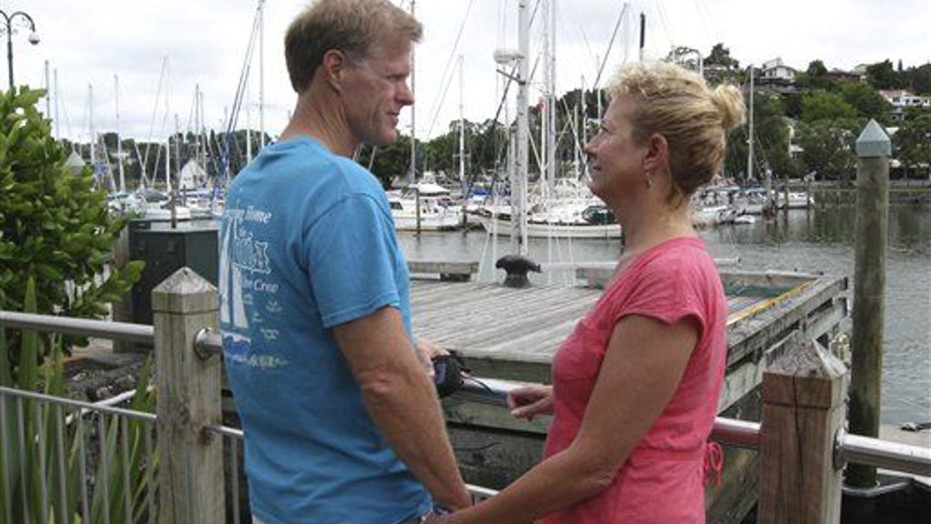 Ricky and Robin Wright, from Lafayette, Louisiana, stand at a dock in the New Zealand port of Whangarei, where the wooden sailboat Nina was moored in 2013.