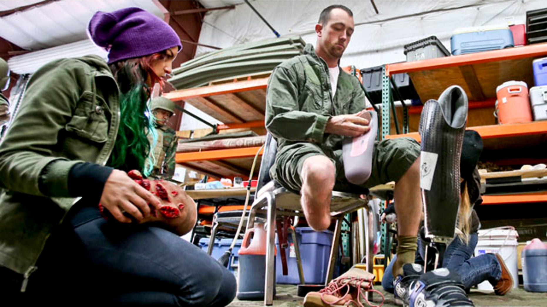 Feb. 12, 2013: Former Navy corpsman Joel Booth, who lost a leg in Afghanistan, prepares with the help of a makeup artist to play his role as a downed helicopter pilot in a military training exercise at San Diego-based Strategic Operation.