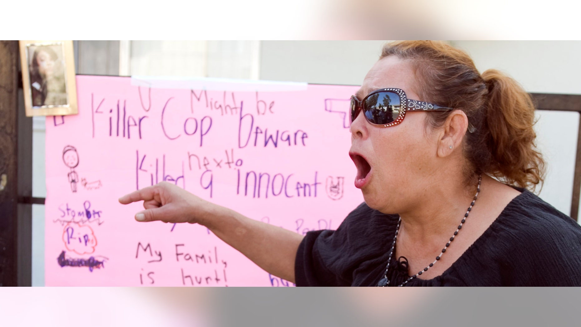 Maria, who wouldn't give her last name because she said she fears the police, shouts "no mas" at a memorial on Anna Drive in Anaheim, Calif. for Manuel Angel Diaz, 25, of Santa Ana, Monday, July 23, 2012.