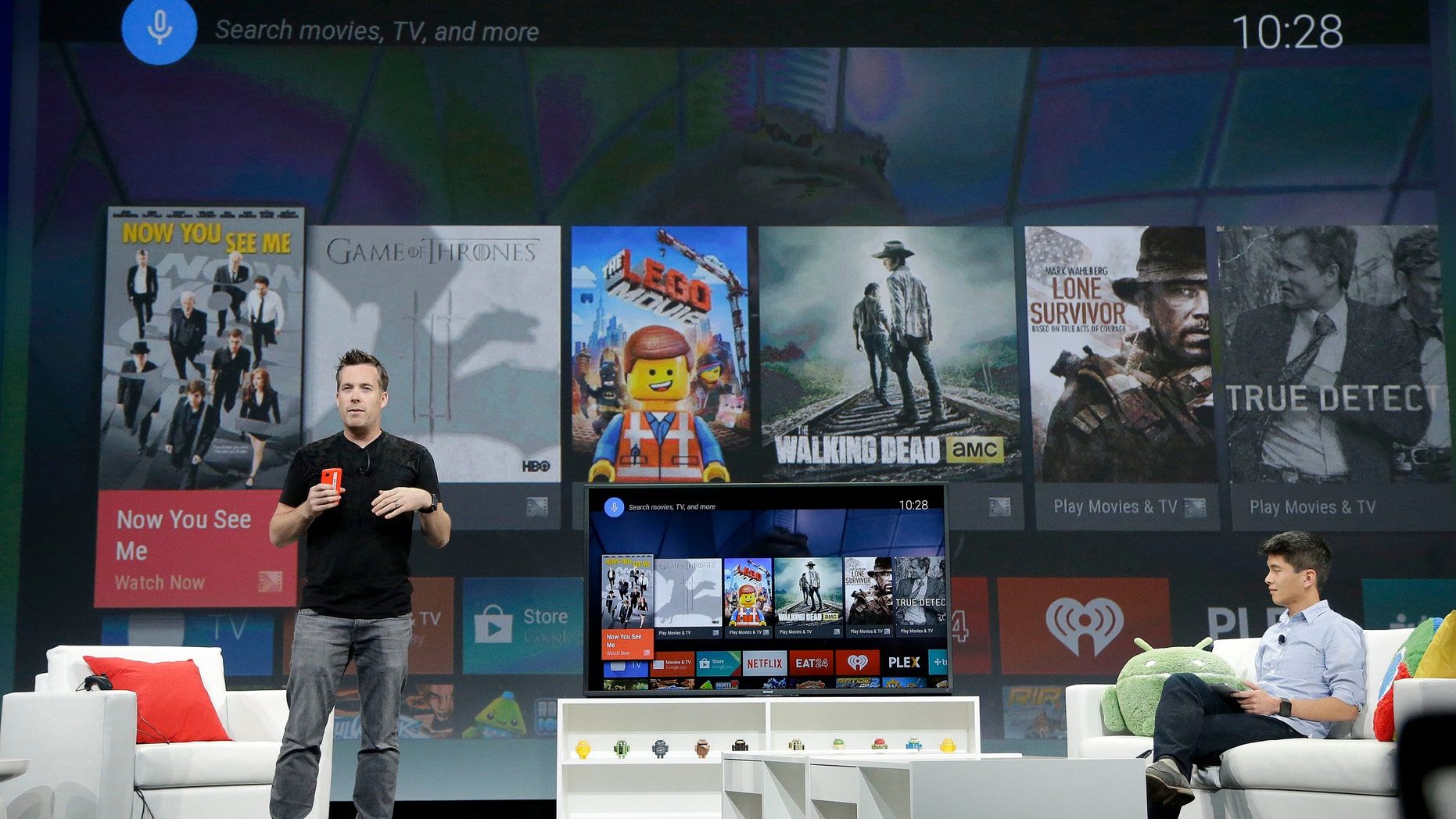 Dave Burke, director of engineering at Android, left, speaks about Android TV during the Google I/O 2014 keynote presentation in San Francisco, Wednesday, June 25, 2014. As the Internet giant's Android operating system stretches into cars, homes and smartwatches, this year's annual confab will expand on its usual focus on smartphones and tablets. (AP Photo/Jeff Chiu)