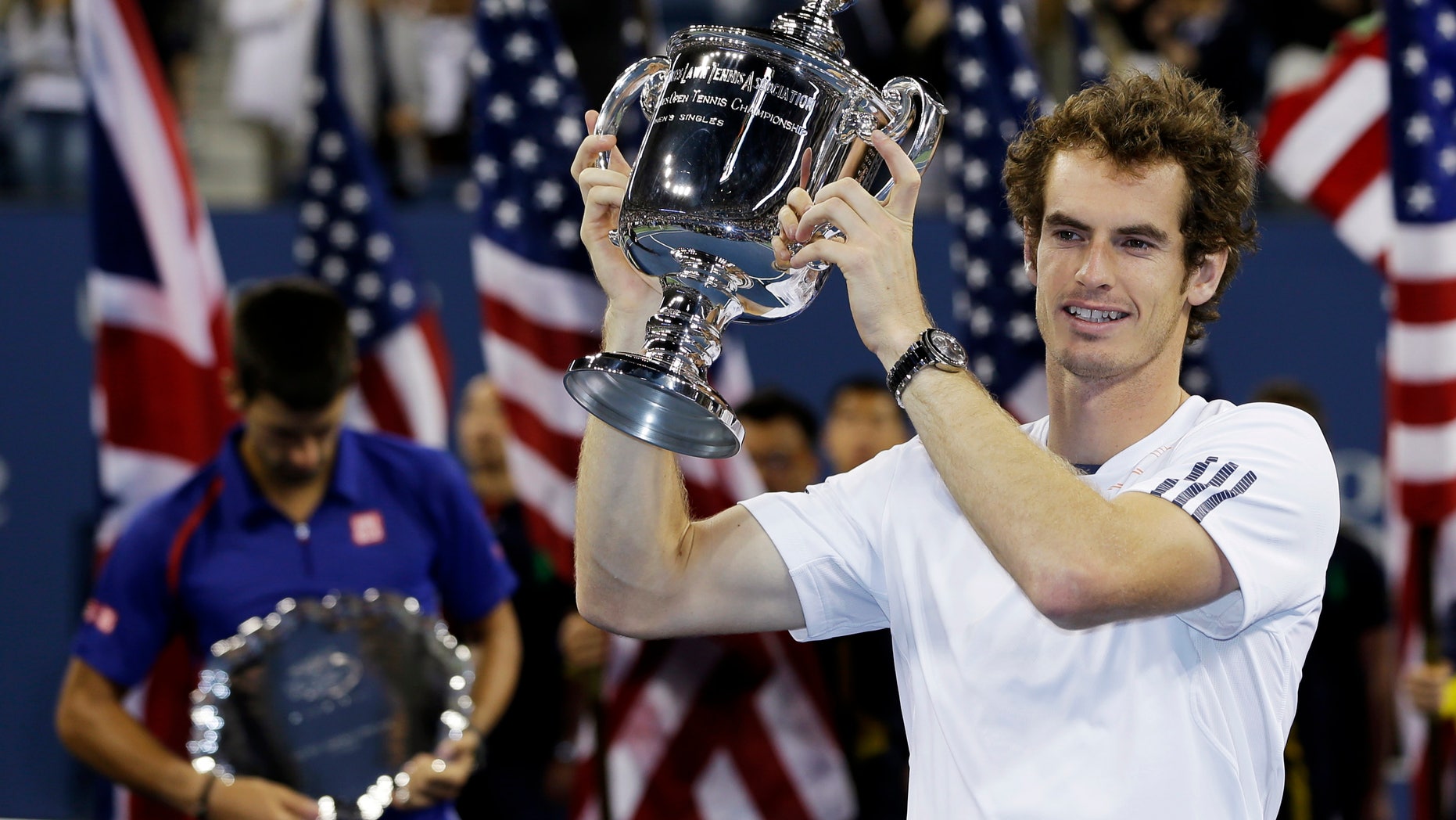Britain's Andy Murray poses with the trophy after defeating Serbia's Novak Djokovic in the championship match at the U.S. Open tennis tournament, Monday, Sept. 10, 2012, in New York. Murray won 7-6 (10), 7-5, 2-6, 3-6, 6-2. (AP Photo/Mike Groll)