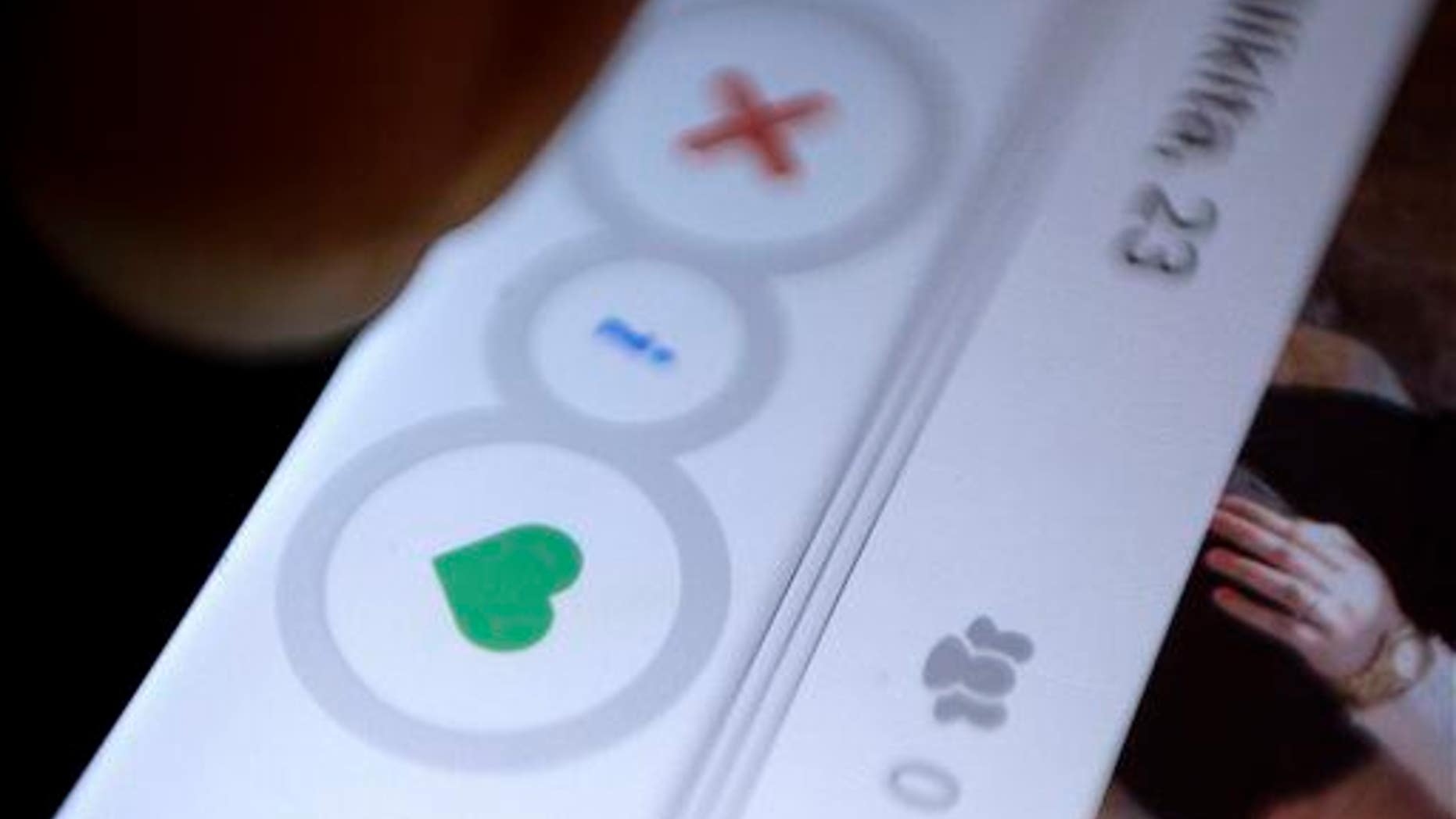 In this July 5, 2015, photo, an Indian man uses Los Angeles-based dating application Tinder in New Delhi, India.