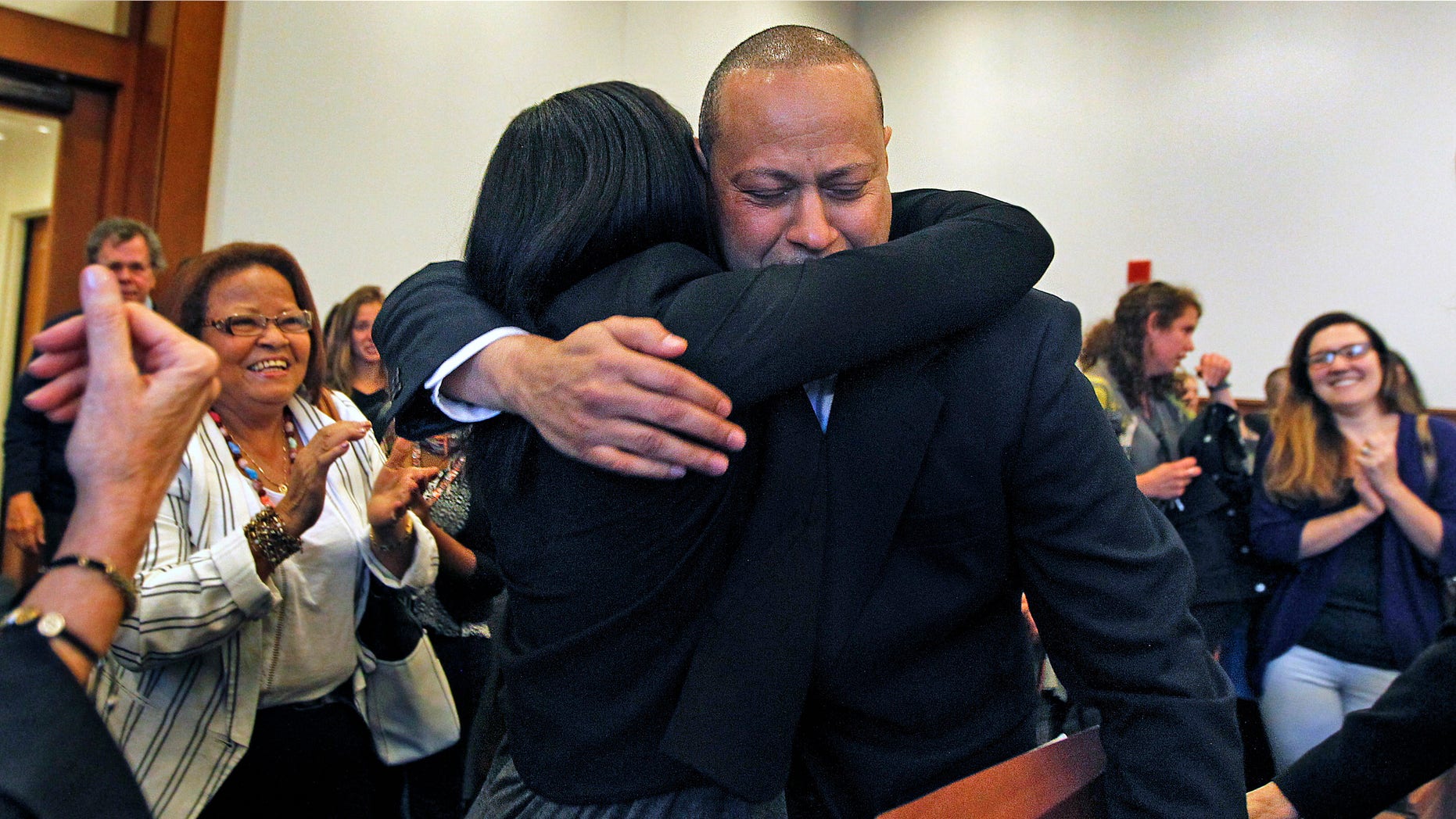 Angel Echavarria hugs his daughter after he is released in Salem Superior Court on May 18, 2015.