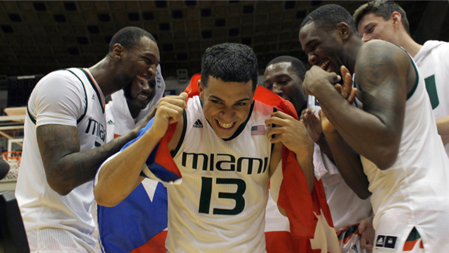 Angel Rodriguez is congratulated by his teammates in San Juan, Sunday, Nov. 22, 2015.