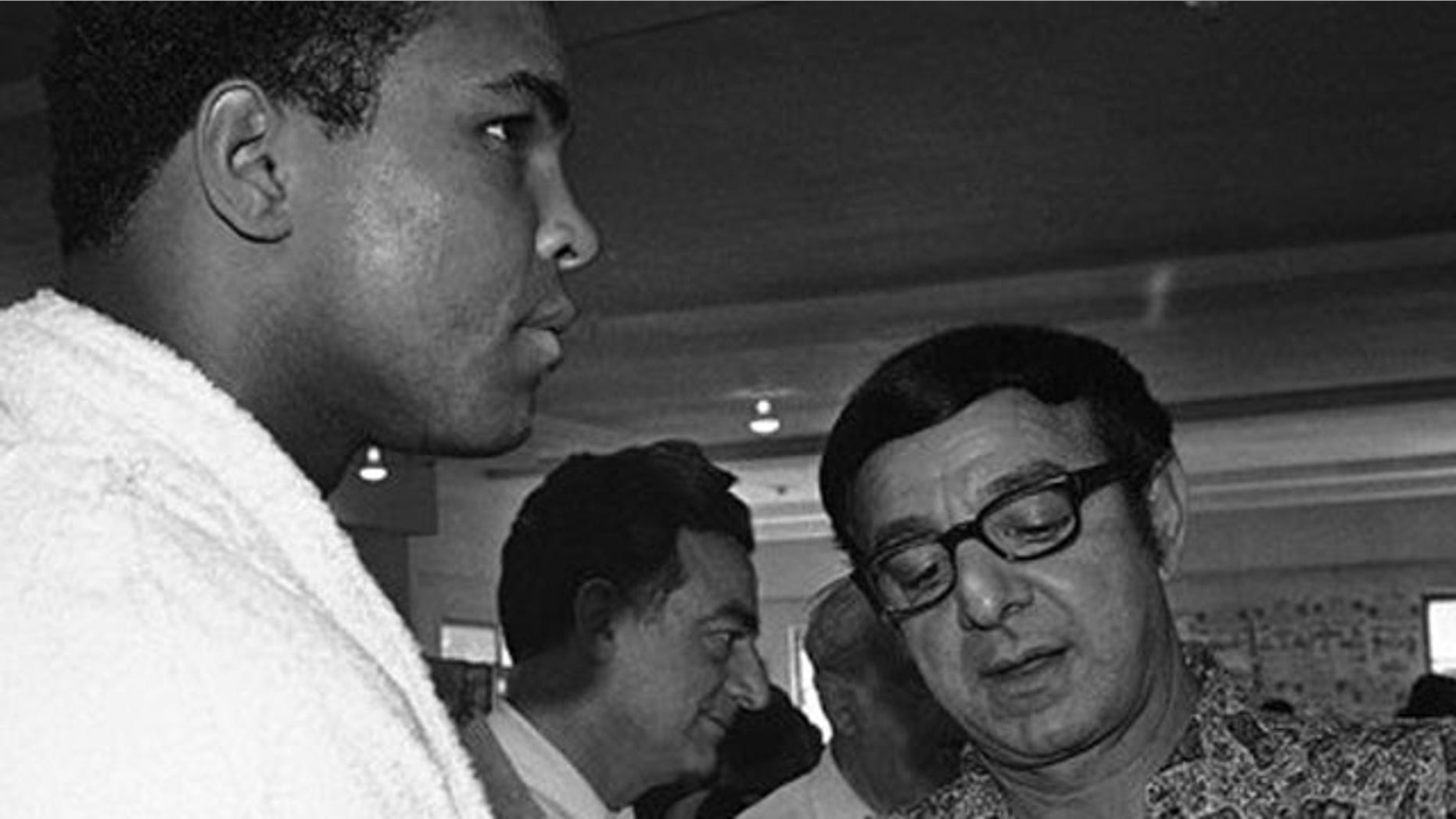 FILE - In this March 4, 1971, file photo, heavyweight challenger Muhammad Ali, left, has fists taped by trainer Angelo Dundee in Miami Beach as Ali resumes his training for an upcoming title bout with champion Joe Frazier in Madison Square Garden.