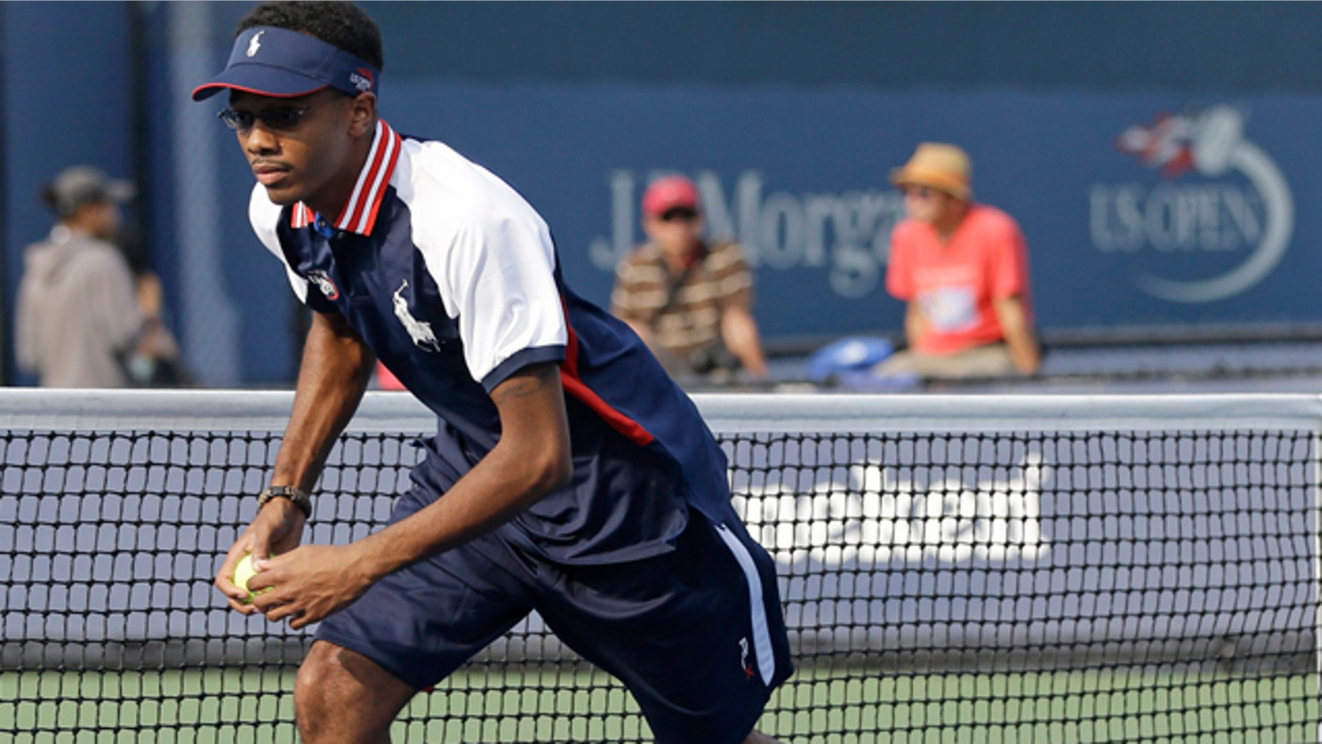 Aug. 21, 2013: Angelo Anderson works during a tennis match as a ballperson at the Billie Jean King National Tennis Center in New York.