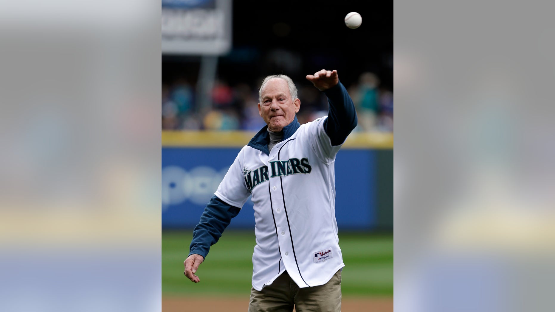 Jim Whittaker throws out the ceremonial first pitch before a baseball game between the Seattle Mariners and the Los Angeles Angels, Sunday, April 28, 2013, in Seattle, Wash. May 1 will be the 50th anniversary of Whittaker becoming the first American to reach the summit of Mount Everest. (AP Photo/Elaine Thompson)