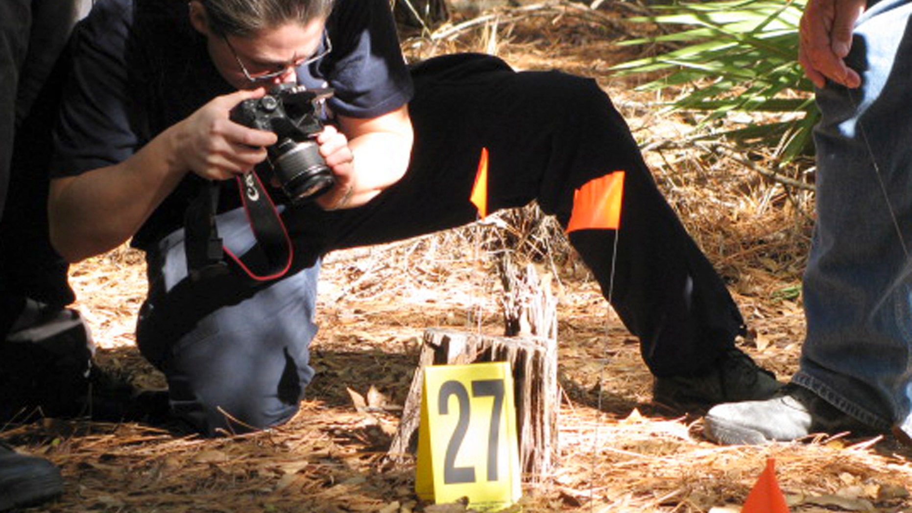 Nov. 11: Diane Robinson of the American Humane Association marks and photographs details of a staged crime scene during a veterinary forensics seminar at the University of Florida in Gainesville, Fla.