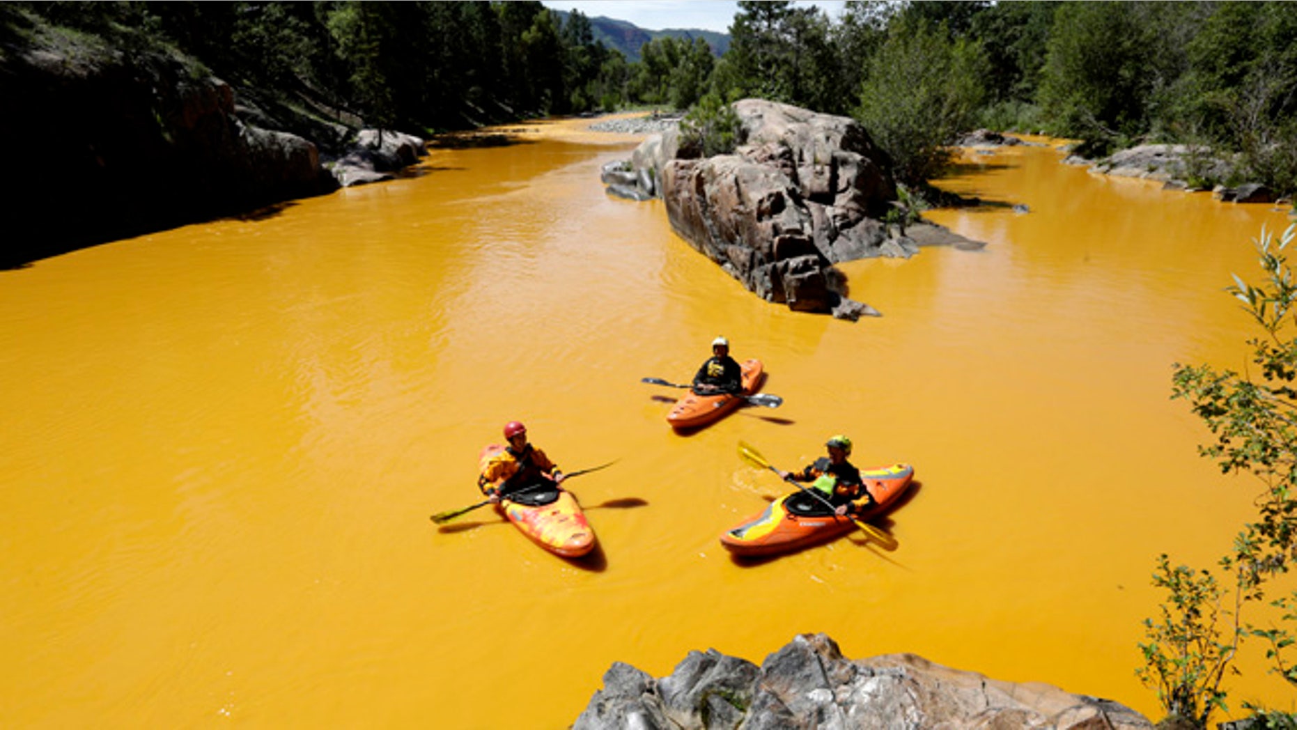 FILE: Aug. 6, 2015: Kayaker in the Animas River near Durango, Colo., in water colored yellow from a mine waste spill.