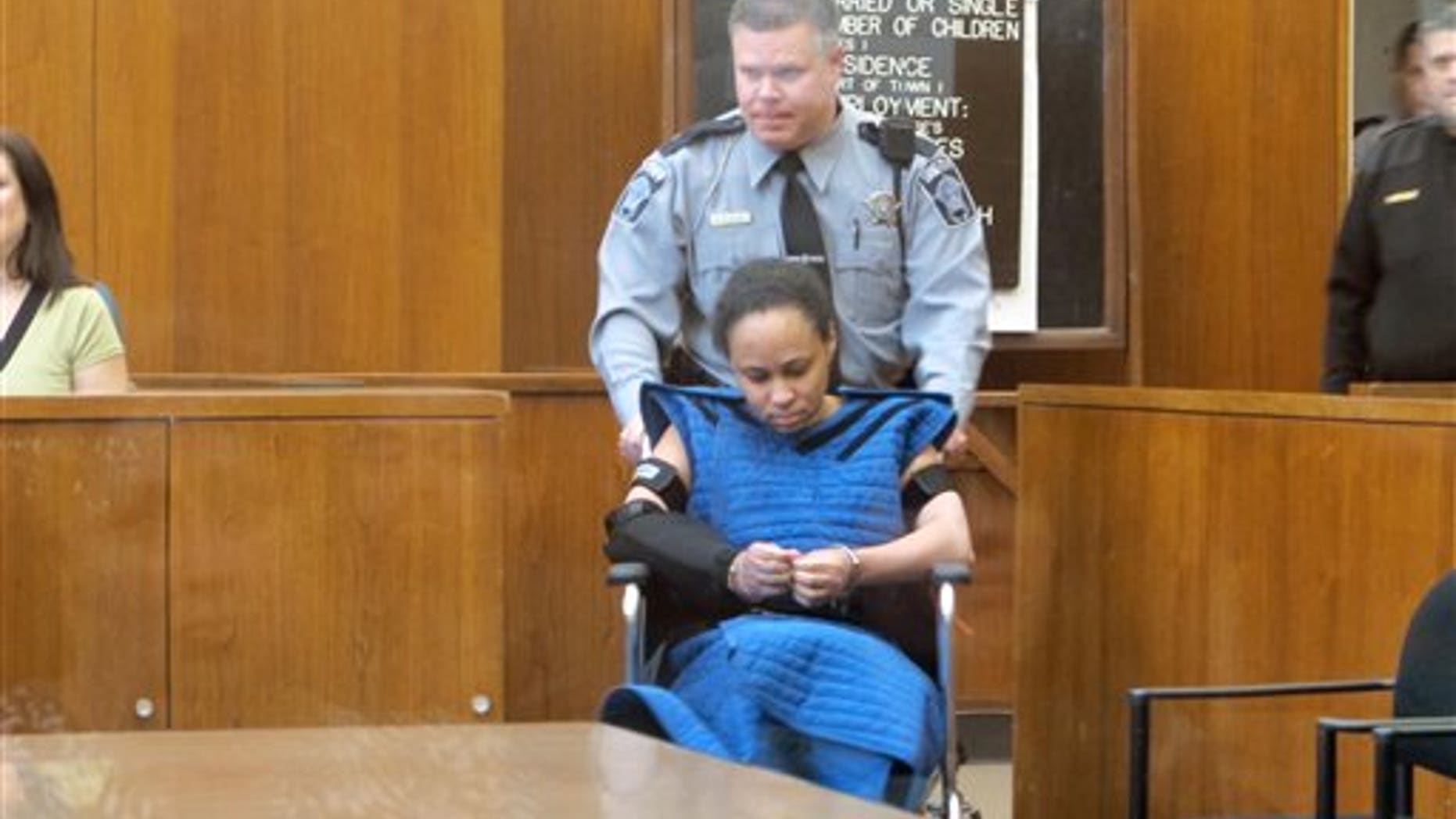 Annette Morales-Rodriguez, who was convicted of killing a pregnant woman in hopes of slicing out the full-term fetus and passing him off as her own baby, is wheeled into a Milwaukee County courtroom. A judge sentenced her to life in prison with no possibility of parole.