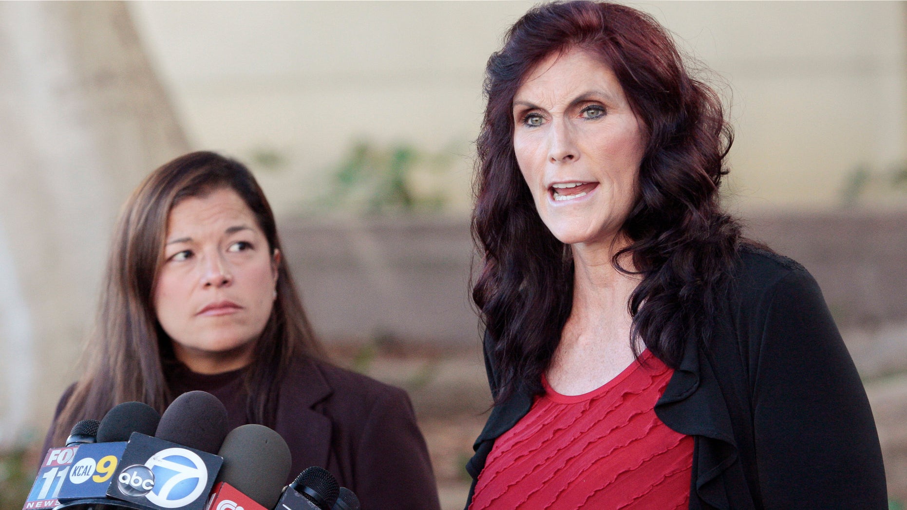 FILE - In this Thursday, Sept. 20, 2012, file photo, Cindy Lee Garcia, one of the actresses in "Innocence of Muslims," right, and attorney M. Cris Armenta hold a news conference in Los Angeles asking a judge to issue an injunction demanding a 14-minute trailer for the film be pulled from YouTube. A federal appeals court on Monday, May 18, 2015 overturned an order for YouTube to take down the anti-Muslim film that sparked violence in the Middle East and death threats to actors. (AP Photo/Jason Redmond, File)