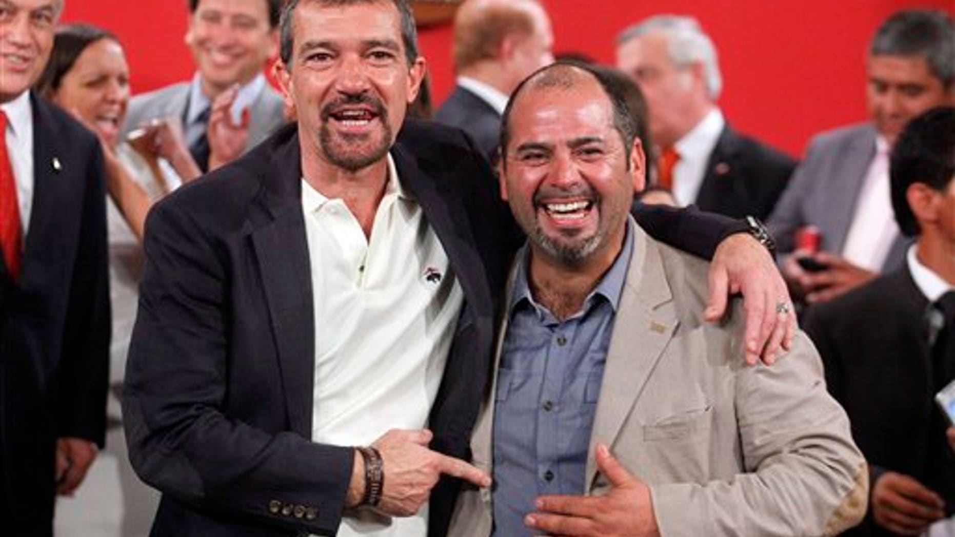 The Spanish actor, Antonio Banderas, left, poses for photographers next to Mario Sepulveda, in Santiago, Chile, Friday Jan. 31, 2014. Sepulveda was one of the 33 miners who was trapped in a mine cave-in in Chile's Atacama desert in 2010. The Spanish star will play Sepulveda, who known as "Super Mario," became the public face of the miners. (AP Photo/Luis Hidalgo)