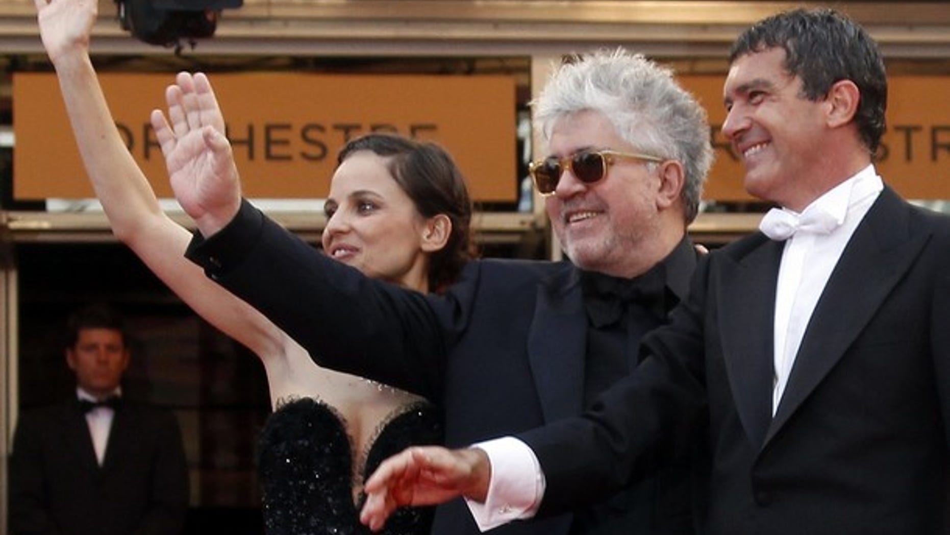 May 19: Director Pedro Almodovar (C) poses with cast members Elena Anaya (L) and Antonio Banderas (R) on the red carpet for the screening of the film 'La Piel Que Habito,' in competition at the 64th Cannes Film Festival.